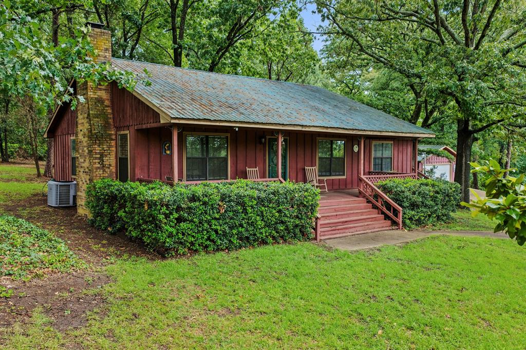 Escape to the peaceful charm of East Texas with this beautiful 3-bedroom, 2-bath cabin nestled on over 2 acres near the sparkling waters of Lake Cypress Springs. Surrounded by mature trees and natural beauty, this property offers the perfect blend of privacy, recreation, and country living.
 Inside, you'll find a warm and inviting cabin atmosphere with either two comfortable living room spaces with two bedrooms or make it three bedrooms, ideal for weekend getaways or full-time living. Step outside and enjoy plenty of room to roam, entertain, or simply relax and take in the serene surroundings. A spacious shop provides excellent storage for boats, vehicles, tools, or lake toys, making this property as functional as it is charming. Located just minutes from Lake Cypress Springs, you'll have easy access to fishing, boating, swimming, and all the outdoor activities this sought-after area has to offer. Whether you're looking for a weekend retreat, investment property, or your own slice of East Texas paradise, this cabin offers endless possibilities. Don't miss the opportunity to own acreage, a shop, and a cabin near one of Texas' most beautiful lakes!