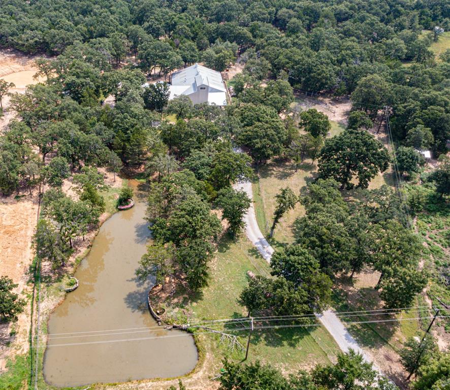 Enjoy quiet country living in this unique barndominium style home with an attached 2 bedroom apartment, located just east of Lake Kiowa and less than an hour from DFW. Nestled among beautiful mature oak trees, this property offers the perfect blend of comfort, flexibility and rural charm. The main home features 2 bedrooms, 2 spacious bathrooms and tall ceilings throughout. The adjoining apartment includes 2 bedrooms and 1 bath, making it ideal as a mother-in-law suite, guest quarters or income producing Airbnb. An oversized attached spray foamed garage provides ample space for vehicles, storage, hobbies or a workshop. Outside you'll find a stocked pond, electric gate and peaceful country setting designed for relaxation and privacy.