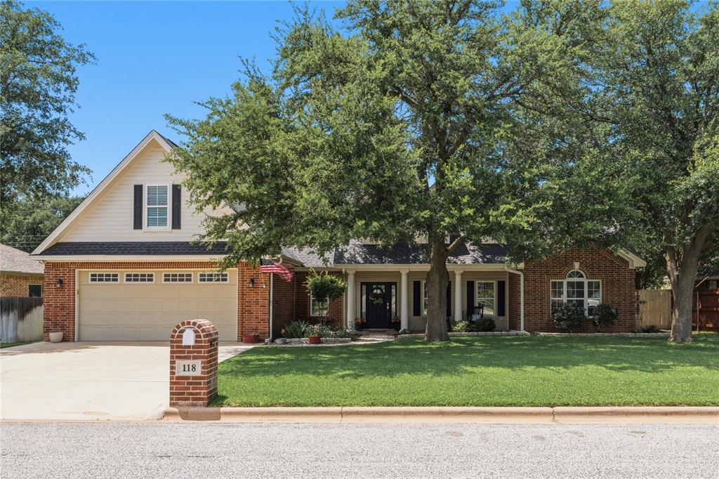 Honey, stop the car! Welcome to 118 Rainbow Drive in Early, Texas—an exceptionally well-maintained home offering the perfect blend of comfort, functionality, and outdoor living. With 4 bedrooms, 2.5 bathrooms, and a thoughtfully designed floor plan, this property is truly move-in ready. The open-concept living area is anchored by a beautiful electric fireplace insert surrounded by custom built-in cabinetry. The spacious living room flows seamlessly into the dining area and kitchen, where a large island provides the perfect gathering space for family and friends. Wood-look tile flooring extends throughout the home, offering both durability and timeless style. Just off the main living area, you'll find a dedicated office or study, ideal for working or schooling from home. Tray ceilings in both the living room and primary suite add architectural interest and an elevated feel, while 9-foot ceilings throughout the home create a bright, spacious atmosphere. The primary suite is a true retreat, featuring double walk-in closets, dual vanities with a separate makeup station, a jetted soaking tub, and a separate walk-in shower. Two additional bedrooms are located downstairs, while the versatile fourth bedroom upstairs can easily serve as a bonus room, game room, and includes a large walk-in closet. Storage is abundant throughout the home, ensuring everything has its place. Outside, the property truly shines. The beautifully landscaped yard is maintained by a water well-fed sprinkler system, helping keep the lawn lush and green. Enjoy relaxing mornings on the covered front porch, entertaining on the covered back porch, or gathering on the expansive backyard patio. A 15' x 11' storage building provides additional space for tools, equipment, or hobby storage. If you've been searching for a meticulously cared-for home with exceptional outdoor living spaces, abundant storage, and a highly functional layout, 118 Rainbow Drive deserves a spot at the top of your list!