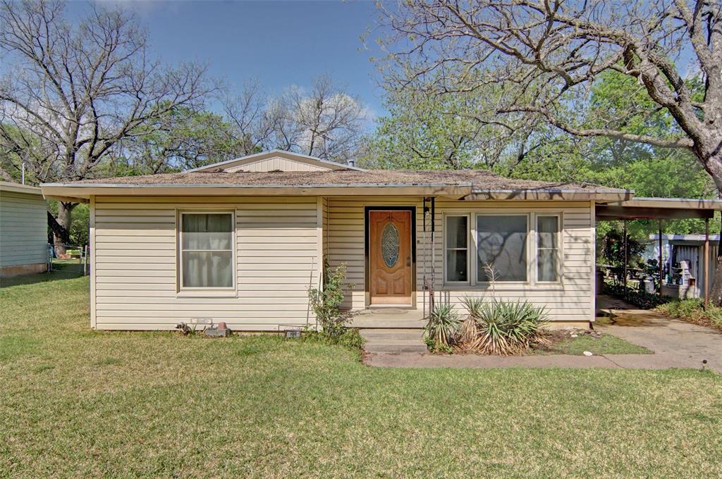 Three bed, two bath home with storage shed accessible through covered breezeway on a nice-size lot with large trees in established neighborhood.