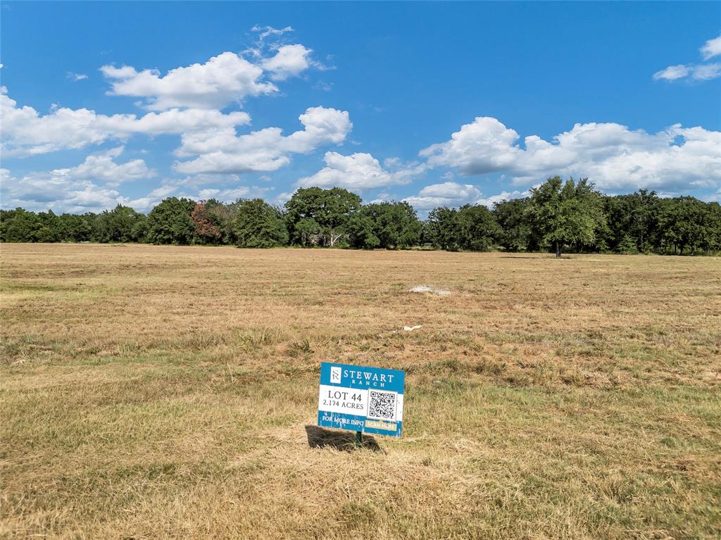If you have not seen Stewart Ranch, Granbury's newest luxury community, stop what you are doing and make the
drive to see it! Located on the Acton Fort Worth side of town sits this beautiful 75 lot, gated development with lots from
1 to 11 acres. Once you turn into the development you will notice a beautifully designed entrance with the peaceful
sound of water features on both sides. Enter the development and experience the wide concrete roads and
underground utilities as you look out over beautiful views of Comanche Peak. This lot is just over 2 acres with
beautiful trees and a pond at the back of the property. This is an absolute golden find. How often do you find a 2 acre property in a gated community with concrete roads and a pond at the back of your lot? If you are looking for a luxury experience in a community with
custom homes, you have found it. Privacy, location, open lots, beautiful views and more. It's a must see!