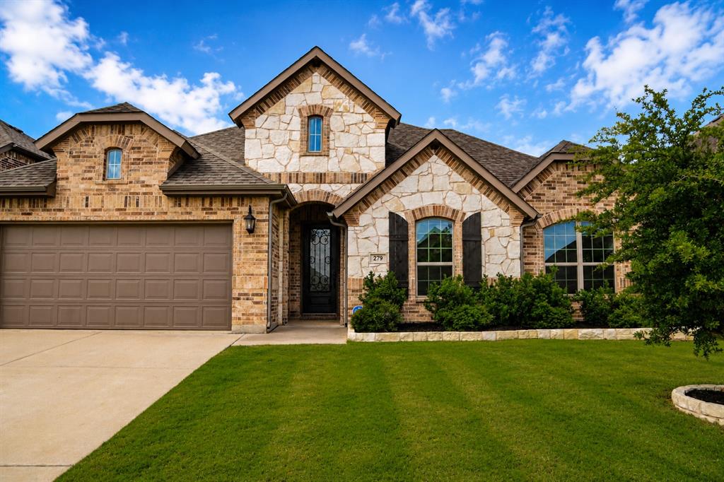 Welcome to 279 Paluxy Street in the sought-after Arabella community of Burleson. Built in 2020, this beautifully maintained 4-bedroom, 2-bath home offers an exceptional combination of thoughtful design, quality finishes, and everyday convenience.

A dramatic tray ceiling welcomes you into the home, leading to rich wood flooring and an open-concept layout designed for both comfortable living and entertaining. The spacious living room showcases a stunning floor-to-ceiling stone fireplace with custom built-ins, creating a warm and elegant focal point.

The kitchen offers abundant cabinetry, generous workspace, a large island, and a bright breakfast area overlooking the backyard. The private primary suite is a true retreat, featuring dual vanities, a relaxing garden tub, separate shower, two oversized walk-in closets, and a beautiful bay window sitting area filled with natural light.

Step outside to enjoy the covered patio and expansive grassy backyard with plenty of room for children, pets, gardening, or outdoor gatherings.

Meticulously maintained, this home receives professional monthly cleaning as well as an annual professional deep clean. Conveniently located within walking distance of H-E-B and just minutes from Target, shopping, dining, and everyday conveniences, this move-in ready home combines comfort, style, and an unbeatable location.