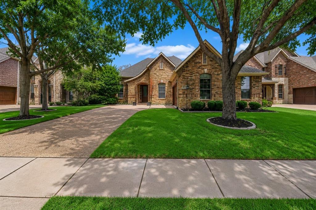 Welcome to this impeccably maintained brick and stone home located in the prestigious gated community of Emerald Park, often referred to as the Hidden Jewel of Colleyville. This charming single story residence offers 3 bedrooms, 2 bathrooms, and a 2 car garage, blending timeless design with everyday comfort in an exceptional location. A welcoming foyer leads into elegant formal living and dining spaces, ideal for entertaining family and friends. The dining room has a butler’s pantry, while the well appointed kitchen showcases quartz countertops, a custom tile backsplash, a center island, gas cooktop, wall oven, built-in microwave, and an oversized walk-in pantry. The kitchen flows seamlessly into the breakfast area and  family room, where a striking stone fireplace with gas logs serves as the focal point, flanked by custom built-in shelving. Expansive windows fill the space with natural light and provide peaceful views of the backyard. Engineered wood flooring extends through most of the home, adding warmth and character throughout the main living areas. The private primary suite offers a relaxing retreat with an elegant ceiling detail and a spa-inspired ensuite bath featuring dual vanities, a corner garden tub, and a separate tiled shower. Two secondary bedrooms are thoughtfully positioned away from the primary suite, providing added privacy for family members or guests. Step outside to enjoy the pergola-covered patio and secluded backyard, an ideal setting for outdoor dining, entertaining, or simply unwinding after a long day. Emerald Park residents enjoy an impressive collection of community amenities, including a picturesque pond, a beautiful blue-water canal accented by four fountains, and scenic walking and biking trails that wind throughout the neighborhood. Offering a perfect balance of sophistication, comfort, and convenience, this exceptional home presents a wonderful opportunity to enjoy life in one of Colleyville’s most desirable gated communities.