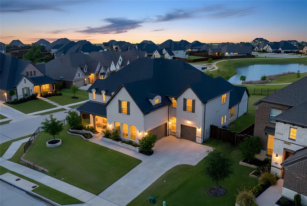 Lovely transitional-style luxury home in the highly desirable Watercress community, situated on a premium 0.41-acre corner lot with serene pond views. Offering approximately 4,875 sq ft, this 5-bedroom, 5.5-bath, 3-car garage residence blends modern elegance, functional design, and upscale finishes.The open-concept floor plan features vaulted ceilings, expansive windows, and abundant natural light, complemented by wide-plank white oak flooring throughout the main living areas. The chef’s kitchen is equipped with KitchenAid appliances, a large island, butler’s pantry, and designer lighting, seamlessly connecting to the spacious living and dining areas—ideal for entertaining and everyday living. The primary suite on the main level offers a spa-inspired bath with soaking tub, oversized walk-in shower, and dual walk-in closets. All secondary bedrooms include ensuite baths, providing privacy and comfort for family and guests. Additional features include a dedicated media room, game room, bonus living area, and oversized utility room, offering flexibility for work, play, and relaxation. Exterior highlights include the corner lot positioning, tranquil water views, and expansive outdoor space with room to customize or build a backyard oasis. A rare opportunity to own a luxury home with space, views, and premium upgrades in a prime Haslet location.