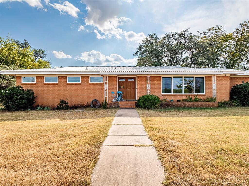 Discover the perfect blend of comfort, space, and opportunity with this inviting 3-bedroom, 2.5-bath home on 1.721 acres. Offering 2,128 sq. ft. of living space, this property features two spacious living areas—ideal for entertaining or family gatherings—and a cozy fireplace that anchors the heart of the home. You’ll love the charm of original wood flooring paired with durable laminate, giving each room a warm and timeless feel.
Step outside to your own private retreat with the large covered patio that’s ideal for outdoor dining or relaxing. Enjoy the fenced 416 sq ft swimming pool, perfect for cooling off on hot Texas days. The land is cross-fenced and ready for small livestock, with plenty of open space and mature trees adding to the serene country atmosphere. For those who need extra storage or workspace, this home delivers—a 4-car carport with attached storage, an RV awning with electric hookups, and an oversized 2-car garage provide plenty of room for vehicles, tools, and hobbies. A large circular driveway welcomes guests while keeping the home set back from the road for added privacy. Zoned commercial but grandfathered for residential use, this unique property offers exciting potential for a small business, home office, or future expansion—giving you flexibility to make it your own. If you’re looking for a property that combines peaceful country living with practical features and commercial possibilities, this one checks every box.
