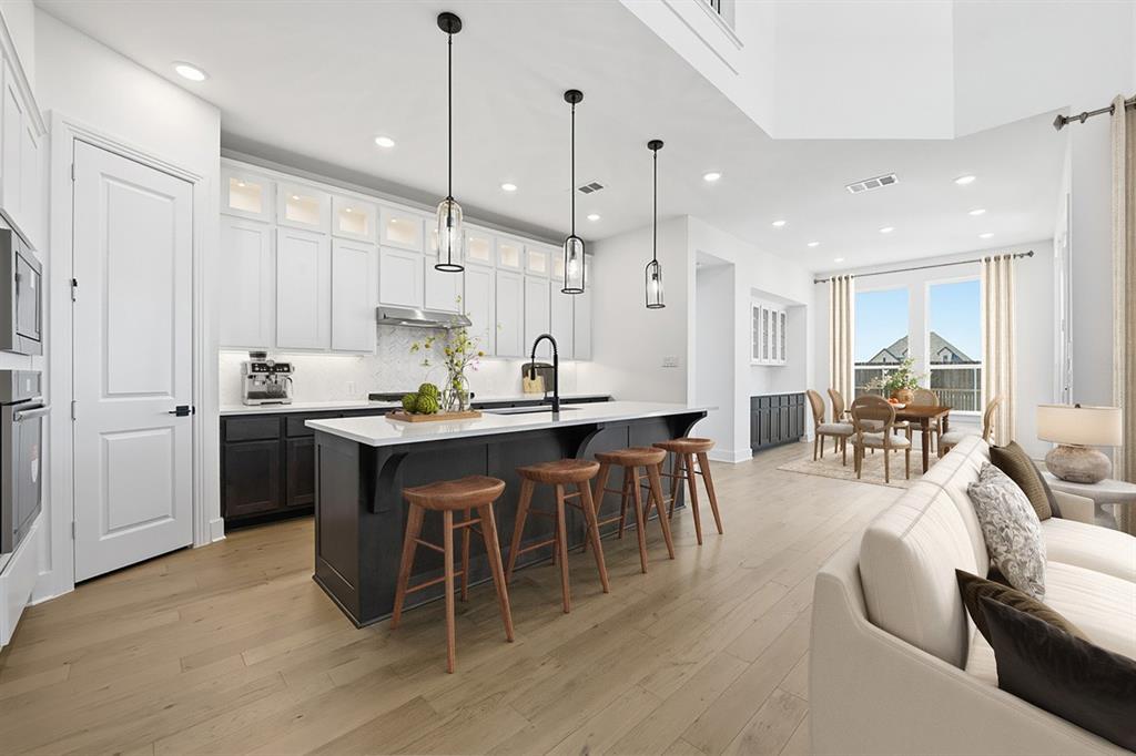 Located in the sought-after community of Tavolo Park, this beautifully designed Highland Home blends modern comfort with thoughtful functionality. Just minutes from Chisholm Trail Parkway, downtown Fort Worth, Clearfork, TCU, and Benbrook Lake, the community offers resort-style amenities including hike and bike trails, parks, a clubhouse, and pool.  This open-concept Middleton plan is filled with natural light, soaring ceilings, and designer finishes such as upgraded tile, elegant engineered wood floors and patterned carpet throughout. The spacious kitchen features an oversized island, abundant cabinetry, and a seamless flow into the dining and living areas. The private primary suite offers a relaxing retreat with bay window, a spa-inspired bath with freestanding tub and separate shower, and a generous walk-in closet. Secondary bedrooms are thoughtfully positioned for privacy and flexibility.  Additional upgrades and features include a floor to ceiling fireplace, extended outdoor living area, front porch, study, entertainment room and loft upstairs and .