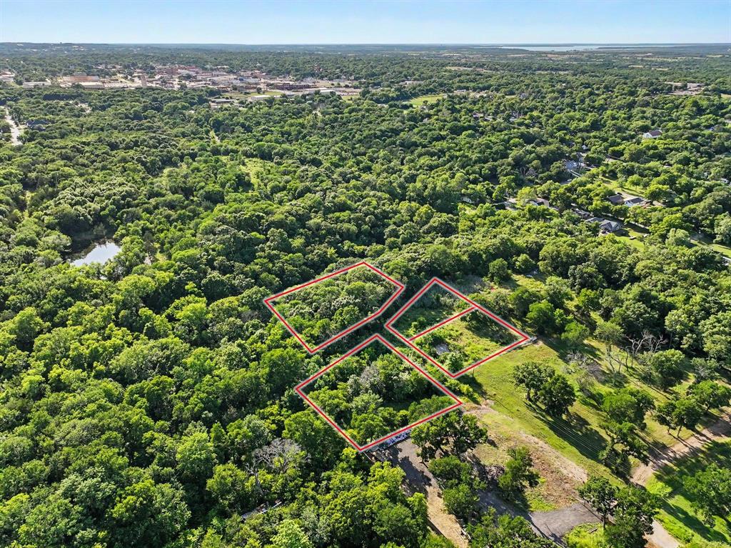 Unique opportunity to own approximately 1.7+ acres across four adjoining parcels in East Denison city limits. Located at 830 E Morgan Street, this heavily wooded property features mature oak, walnut, and elm trees, a beautiful creek, and a private setting with endless potential. Existing improvements include a 1920-built home approximately 1,008 sq ft that is considered a tear-down, along with an older water well that may require repair or replacement. Electric is available on-site. Property currently does not have city water or sewer infrastructure. Access is via gravel road. All parcels to be sold together. Property is being sold AS-IS. No survey will be provided; buyer will be responsible for obtaining a new survey if desired. Ideal opportunity for investment, recreation, future development, or someone looking for acreage within city limits while maintaining a secluded feel. Cash purchase preferred. Buyer to verify all information. No and or assigns, wholesaling, or seller financing. End buyers only.
