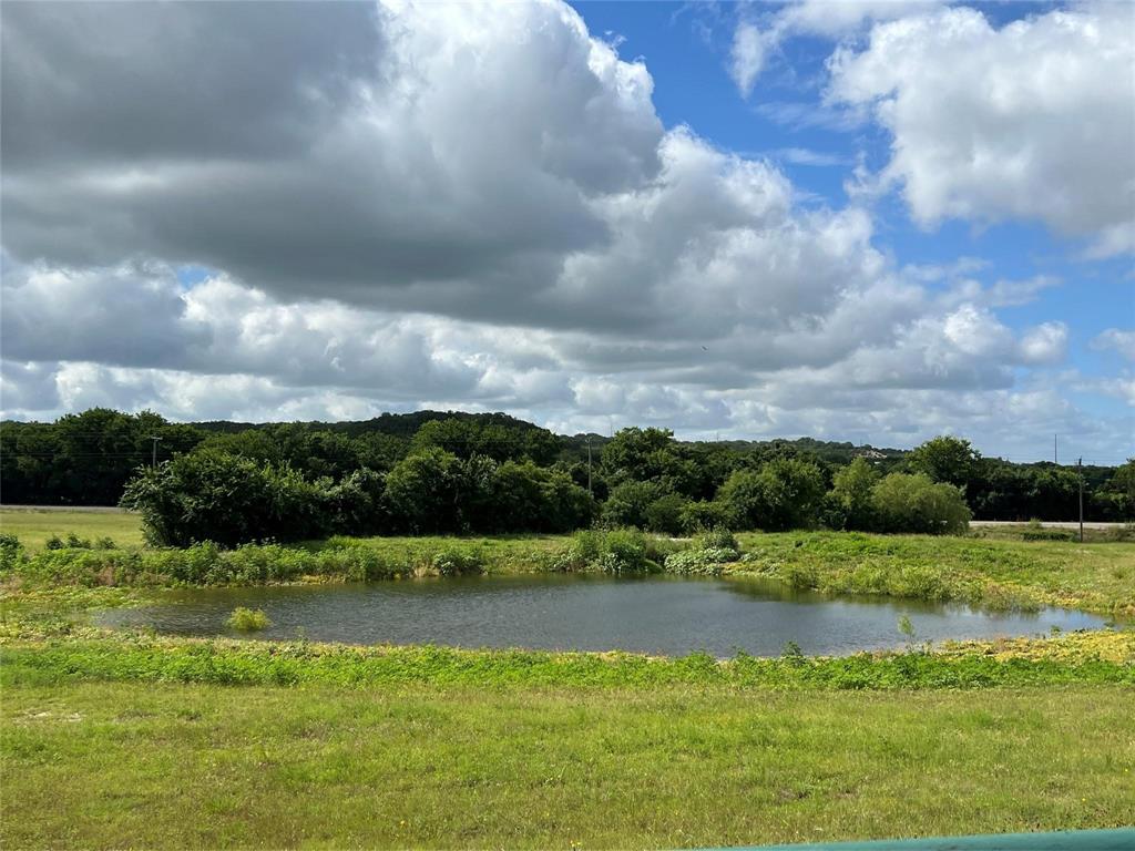 This 22.6 Acre Investment Property with approx 2300 ft US Hwy 67 Frontage as well as an additional entrance and 179 ft frontage on 
CR 308 features 14.37 Acres in Somervell County set up as an RV Park with 29 sites and a  Private Laundry Building for guests.  
    Property also features an 1800 sf Barndominium with large covered porch, and roll up doors , which could be used as a Community Center, or leased out for large gatherings.  There is an additional residence with 1 bedroom, 1 bath, kitchen and laundry, with covered porches and beautiful views, which could be used for Management quarters.  Layout allows for multiple streams of income or family compound.  Picnic tables and large pond,  make outdoor activities available.  So much room for expansion Property is completely fenced and cross fenced with 2 entryways.
7.8  Acres are included and located in Johnson County.   Conveniently located between Cleburne and Glen Rose, and minutes to the Brazos River with Canoe and Rafting Rentals. RV Park does have Rules in place for age and aesthetics on RVs, as well as guest etiquette. 

Turn Key Property, Land, Improvements, and Most Furnishings included with Sale,  Active Leases will transfer upon expiration of current lease.
LLC, Internet Branding,  and Social Media Business Name will not transfer

Investors Welcome
Please Call for Private Showing
