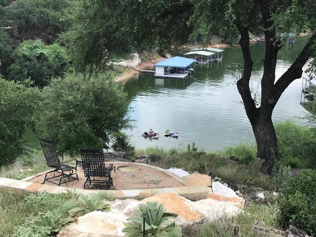 WATERFRONT* GOLF COURSE LOT* PRIVACY ON 3.14 AC * ENERGY EFFICIENT * CUSTOM CRAFTSMANSHIP. Golfers welcome back to the newly renovated Arnold Palmer designed golf course at Barton Creek Lakeside! The course & club facilities received a multimillion $$ renovation & is back in full swing. This country club lifestyle behind 24 hour guarded gates of BCL offers the best in golf, pickleball, tennis, fitness, dining and a full service pool--there's even a marina for residents only - THE WATER IS BACK. This magnificent estate home sides the 8th Fairway and has direct waterfront access to large cove on Lake Travis. The 5,547 sqft 4bed 4.5bath 3+ car garage was uniquely built by John Hagy Custom Homes w- a focus on Energy Efficiency built w- ICF construction-(concrete forms, walls) for a true lifetime home. It also has 10- 250' wells for the Geothermal heating-cooling systems & a newly added solar panel system all maximizing energy efficiency. The quality & attention to detail is evident throughout the entire home-rich solid knotty alder cabinets, solid alder baseboards, wood & stone floors, rare walnut coffee hued Cantera stone columns in-outside & top graded encased crank windows & more. Off the grand foyer is a 1100 bottle wine room & the massive Primary suite, exec study, safe room, planning center, chefs kitchen w- top tier SS appliances, fully equipped media room, mud room & laundry room, 2 guest bedrooms & bathrooms are all on the first level with a short elevator ride to the upstairs guest suite & game room w- full bar and terrace overlooking the lake & Hill Country. There is an Infinity spa-pool (Spool) off of the expansive back patio living area complete w- full outdoor kitchen & a waterfall for ambiance. Seller has recently installed a built in SS Thermador side by side refrigerator & dishwasher; a new AC unit & has transformed this beauty into a Santa Barbara styled masterpiece. GO TO YOUTUBE 26804 SEPT2025 HD 720p FOR A DESCRIPTIVE VIDEO. MOVE IN READY!