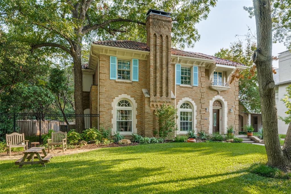 Situated on one of Dallas’ most cherished streets, this historic three bedroom, three and a half bath Lakewood Boulevard residence is a rare gem that blends timeless architecture with thoughtful modern updates. Nestled on a large lot with the best trees on the block. Steeped in character and charm, the well-built home features original details throughout—including large, vibrant stained glass windows that bathe the interior in color and light and a Rookwood tile Fireplace with gas logs in the Formal Living Room.
A spacious eat-in kitchen offers both function and comfort, perfect for casual meals or morning coffee, while a separate formal dining room provides an elegant setting for entertaining. All the rooms are oversized with beautiful hardwood floors. The Sun Room provides a casual setting as it takes in the light and beauty of the back yard with its wall of windows. 
The Library features arched windows, built-in bookshelves and cabinets. Upstairs, beautifully appointed, spacious bedrooms and classic period details continue the home's vintage charm. The property features a detached garage with private quarters (642 sq ft) that feels like a tree house with a full bath and balcony above—ideal for guests, an office, or studio space. The property features solar power with batteries plus an EV charger...unique modern amenities in this 100 year old classic!

All just moments from White Rock Lake, Lakewood Country Club, Whole Foods, Restaurants, shopping and Lakewood Elementary, this is your opportunity to own a piece of Dallas history in one of the city’s most iconic neighborhoods.