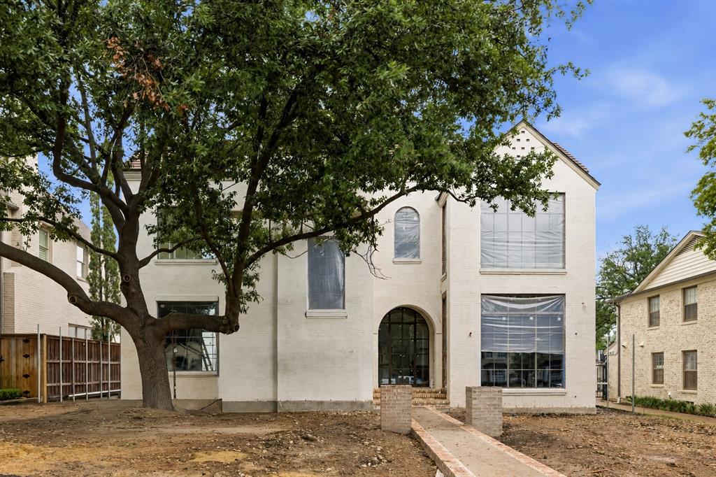 A rare offering by Jarrett Construction on a premier 70x150 lot, zoned to Hyer Elementary. Designed by Jason Luter Architects, this pre-completion opportunity delivers a level of architecture, materials, & execution rarely seen in today’s market. Slurry brick, a tobacco-colored clay tile roof, & an arched steel front door establish a timeless presence, while floor-to-ceiling Lepage windows & doors flood the interiors with natural light. Pier & beam construction underscores the integrity of the build. Inside, 7-inch wide rift & quartered white oak floors anchor a series of refined spaces. The gallery entry makes an immediate statement with herringbone brick flooring & a tongue-and-groove white oak ceiling with beam detail. The dining room is elevated with parquet hardwoods, a cove ceiling, & hand-applied plaster finish. A true focal point, the showcase bar sits between the entry & dining, complete with floating marble shelves & wine refrigeration.The kitchen blends function & design with a walnut island, custom cabinetry, Wolf & Sub-Zero appliances, scullery, & dedicated breakfast room.Living spaces open seamlessly to the outdoor loggia with automatic screens,in-ceiling heaters,& an Isokern fireplace overlooking the pool & spa.Mature landscaping & turf create a private, low-maintenance setting.The study features built-ins,a coffered ceiling,designer wall coverings,& pool views. A flexible downstairs suite serves as a guest retreat or pool cabana-lounge,complemented by a full pool bath.Additional spaces include a mudroom with built-ins & a discreet pocket office with secondary laundry.Upstairs offers dual staircases, elevator-ready design, gym, playroom, & a third-floor bonus space with full bath—ideal as a sixth bedroom or additional living.The vaulted primary suite includes a sitting area & spa-inspired bath. All secondary bedrooms offer en-suite baths & walk-in closets. Custom homes at this level, in this location, rarely come available—unless they’re commissioned.