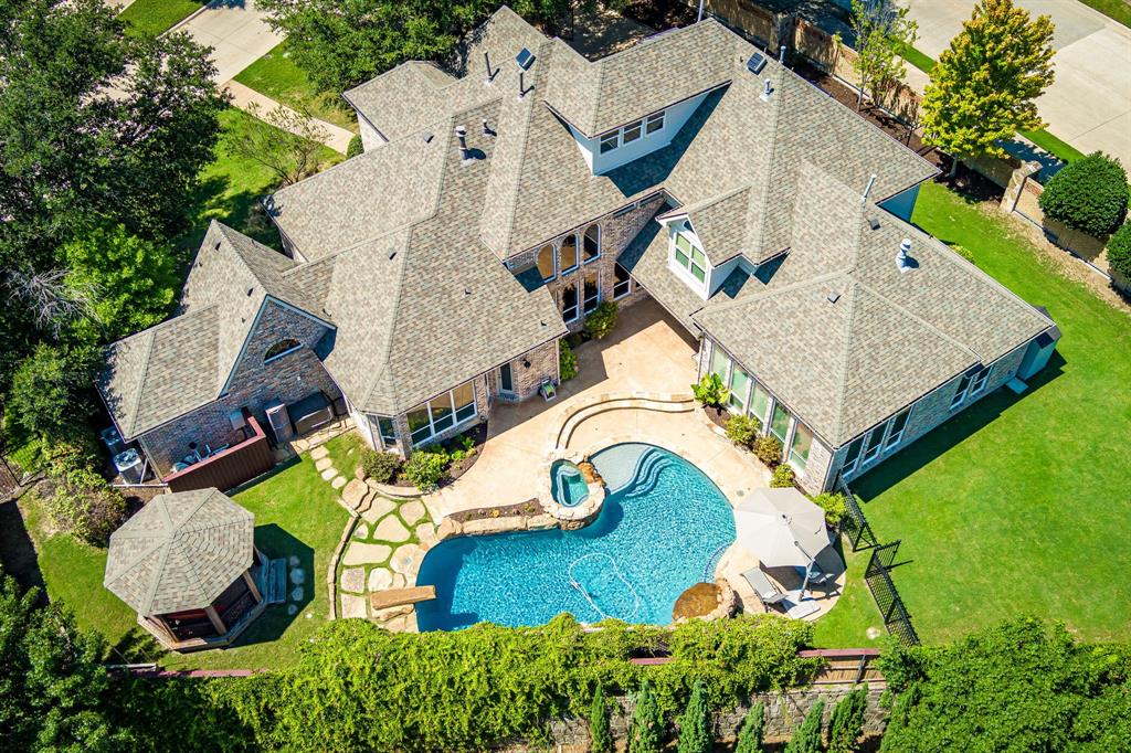 Welcome to your own private oasis, a true backyard paradise featuring a sparkling salt water pool, inviting spa, and generous side yard perfect for outdoor entertaining and play. Whether you're hosting lively summer pool parties or enjoying quiet evenings under the stars, this outdoor retreat is the centerpiece of the home. Inside, discover a meticulously crafted 5-bedroom, 4.5 bathroom  home, that seamlessly combines luxury and comfort. This home features, Hardwood floors, custom built-ins, integrated sound speakers, soaring ceilings, and elegant crown molding The formal living and dining rooms are ideally situated for entertaining, featuring a cozy fireplace and a wall of windows that provide views of the backyard. Working from home is a breeze in the dedicated study, complete with French doors, a custom built-in bookcase, and a functional desk space. At the heart of the home is a chef’s dream kitchen, equipped with a premium 8-burner gas cooktop, quartz countertops, glass subway tile backsplash, and a large center island. The adjacent family room includes a second fireplace and custom built-in shelving, making it an inviting space for everyday living. The primary suite, located on the main floor, features a spa-inspired bath with dual vanities, a soaking tub, walk-in shower, and a custom walk-in closet. A separate half bath offers convenient access to the pool and outdoor areas. Upstairs, enjoy a game room and a fully equipped media room complete with built in cabinetry, an electric drop down screen, and projector. Three additional bedrooms each include walk-in closets, with two connected by a Jack-and-Jill bathroom. The fifth bedroom, located privately on the third floor, offers flexible use as a teen retreat, or home office. Located in the prestigious Winding Creek community, with close proximity to restaurants and shopping and access to parks, trails, and playgrounds. Style, space, and substance, this home truly has it all. 
Dual generators