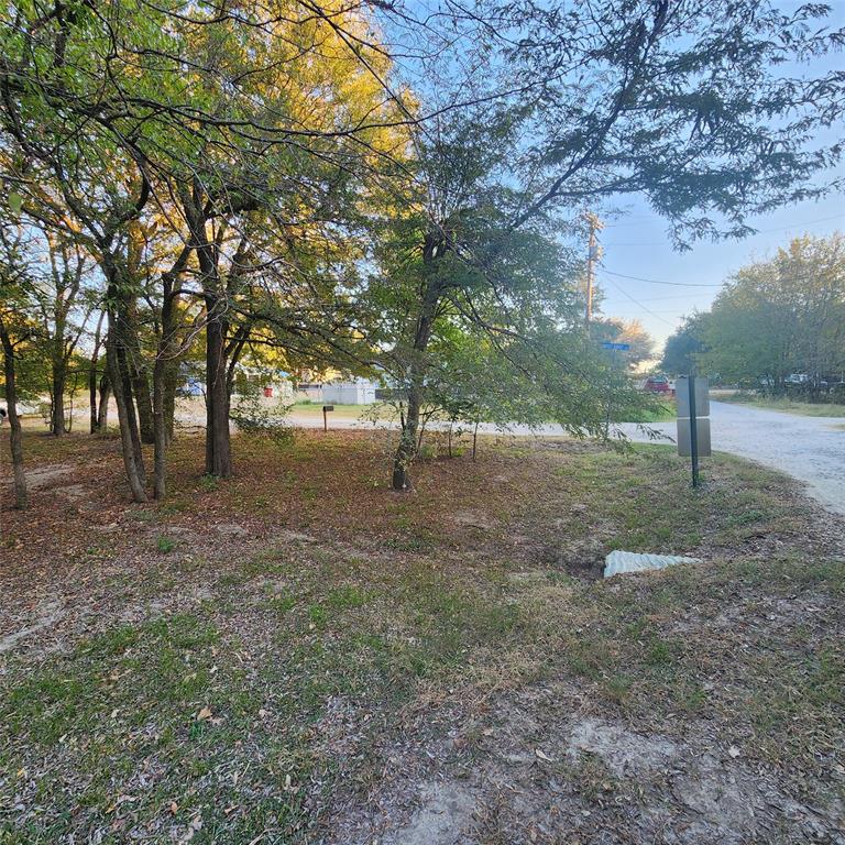 Wooded corner lot available in a lakefront community on Lake Tawakoni! City water and sewer available, Nice neighborhood boat ramp, fishing pier and picnic area. Build your weekend cabin or full time lake home. Minimum sq ft is 1000 and site built only.no manufactured housing. Located near the city recreational park, Deer Run Golf Course and additional boat ramps and restaurants.  All information is approximate, buyer and buyers agent to verify with the city of West Tawakoni.