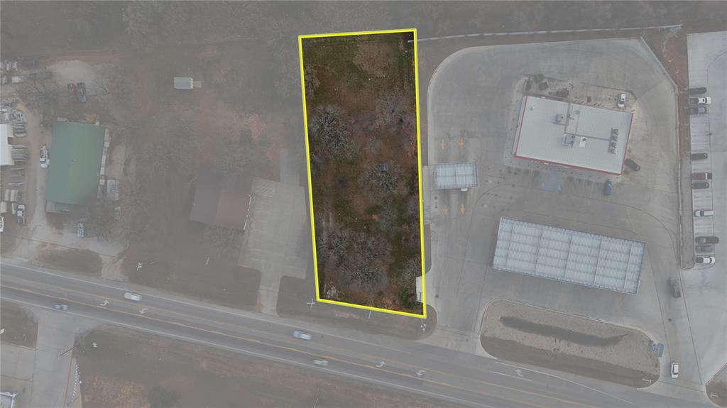 Exceptional commercial lot located directly on highly traveled Highway 199, offering outstanding visibility and easy access.  This .75 acre tract sits next door to Allsups, benefiting from established traffic flow and a shared entrance for convenient ingress and egress.  The property features large mature trees providing natural shade and an attractive setting for a variety of commercial uses with city utilities available, development is streamlined and ready for your vision.  Ideal location for retail, office, service business or investment opportunity.  High traffic counts, excellent exposure and proximity to an established national convenience store makes this a smart choice for your next project.