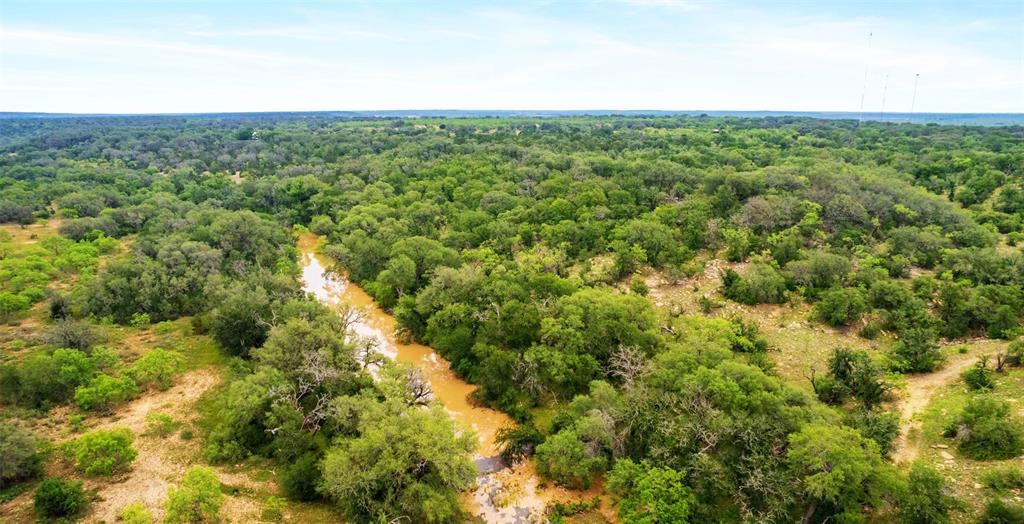 336 ACRES BROWN CO. HIDDEN GEM RANCH! This is a must to see to experience this ranch and all it has to offer. The front half of the ranch is a mesquite flat that has the potential to be renewed for cultivation or planted to yield a higher production for native grasses. The boundary fences are good barb wire and net fencing that allows you to put the property to work immediately if one chooses. The property boasts 3 stock tanks and cross fencing that makes for the perfect opportunity for pasture rotation and grazing management for all types of livestock from cattle, sheep or goats. Towards the center of the property is a small barn for feed or storage along with large livestock traps and working pens.  The hidden gem at the back of the property is the split canyon of Clear Creek and Clear Creek that run the length of the back boundary line. The steady elevation change from the front of the property to the back is a wildlife haven including whitetail, turkey, and hogs. The top of the plateau and down into the creek bed is covered in rock outcroppings, mature oak trees, heavy cover and skyline views. Clear Creek is a historic landmark in the area that has kept the country teaming with wildlife and water supply for generations. Paved access and approximately 10 miles south of Brownwood you will be hard pressed to find a property offering the uniqueness of this gem. Brookesmith water is available at the gate and 200 amp electricity service has been run deep into the property
