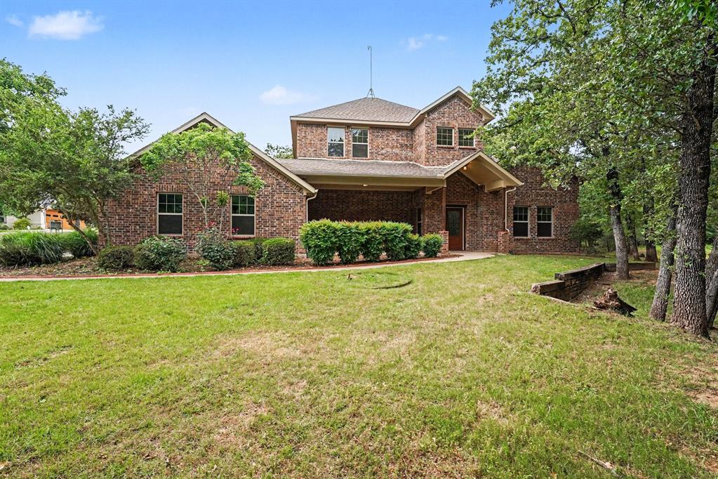 Step into 2190 County Road 2027, recently enhanced with fresh interior paint and partial flooring replacement. The living area includes a fireplace, while the kitchen features stainless steel appliances, an accent backsplash, and a practical island. The primary bathroom provides double sinks and a separate tub and shower. Outside, a covered patio overlooks a fenced in backyard. Move in and experience updated comfort and practical outdoor space. Home comes with a 100-Day Home Warranty and a 7-Day Home Test Drive to move in 7 days early for free