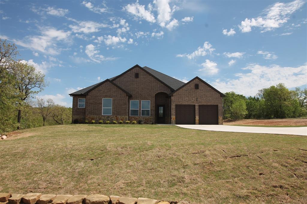 Custom home, gated community, cul-de-sac, 4Bed, 3Bath,2 Liv, 2 Din, 8 ft doors,12 ft ceilings, hand scrapped wood floors. Foyer, opens to the GR, vaulted beamed ceilings, stone electric fireplace, 8 ft windows to enjoy the outdoors & covered patio. GR is open to kitchen, tons of cabinets*adjustable shelves-slow*close feature, SS appliances, double oven, convection microwave, dishwasher, double sink, walk-in pantry, ample counter space*oversized island. One end of the home offers privacy for primary bedroom*ensuite, lg walk-in closet, dual vanity, free standing soaker tub & beautiful seamless oversize glass shower. Three additional bedrooms, plus an office, & game*reading room. One of the best locations in a beautiful gated community, Lake Bridgeport,12,000-acre lake, first choice of boaters, skiers, & fishing. This community offers paved streets, city water, underground utilities, community pool, pickle court, boat dock & day slips for the use of owners & their guests. Come enjoy this lake community.