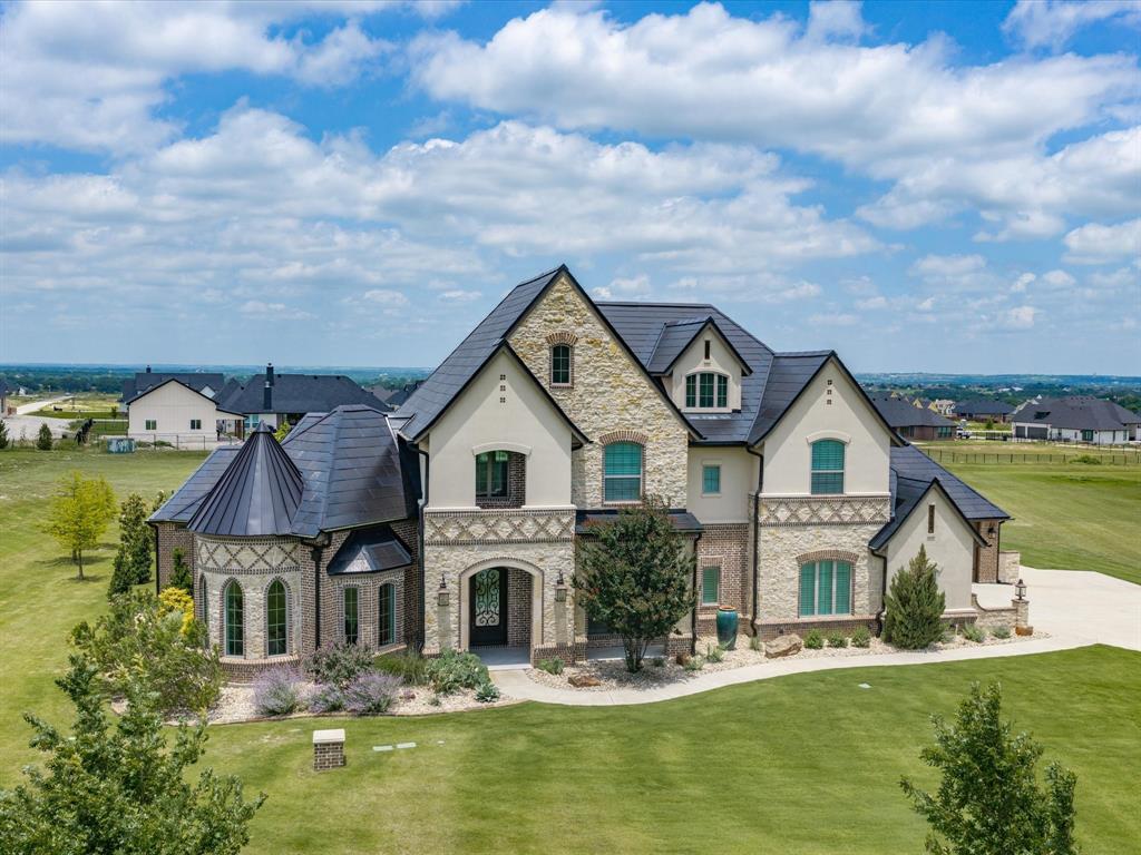 Extraordinary European Country inspired home in one of the most desirable additions in Aledo -- La Madera Estates! Superbly built with perfect blend of sophisticated yet livable style and appointed from head-to-toe with gorgeous finishes and state-of-the-art amenities including TESLA Powerwall Backup Power Grid plus Class 4 rated TESLA Solar Roof Tiles — ultra energy efficient and arguably the most impressive feature of the home! Bright and open design chef's kitchen with SS commercial grade appliances, 6 burner cooktop and double ovens. The kitchen opens to impressive great room with high ceilings, impressive floor to ceiling stone fireplace, gleaming hardwood floors and great windows overlooking it's incredible resort-like backyard! Fabulous outdoor pool cabana with built-in BBQ grill and outdoor kitchen and living space overlooking a stunningly sleek pool with Pentair LED color lighting, pristine landscaping (including $27K in nice, new trees just planted) and gorgeous views of serene lake and pretty estate properties all around!