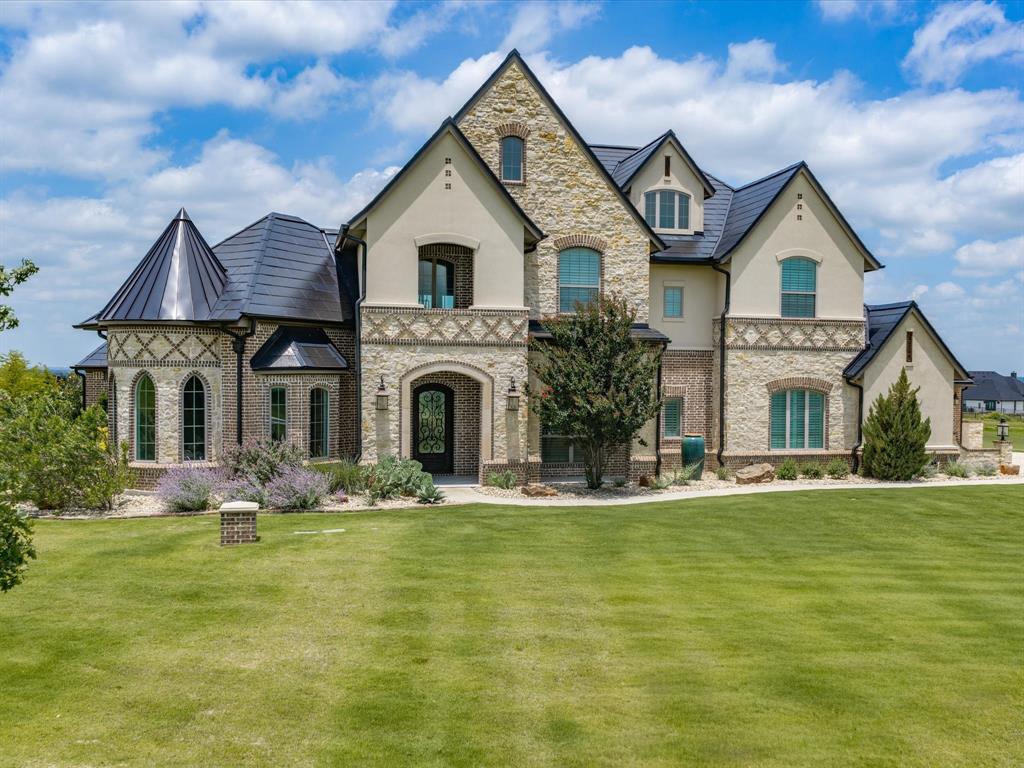 Extraordinary European Country inspired home in one of the most desirable additions in Aledo -- La Madera Estates! Superbly built with perfect blend of sophisticated yet livable style and appointed from head-to-toe with gorgeous finishes and state-of-the-art amenities including TESLA Powerwall Backup Power Grid plus Class 4 rated TESLA Solar Roof Tiles — ultra energy efficient and arguably the most impressive feature of the home! Bright and open design chef's kitchen with SS commercial grade appliances, 6 burner cooktop and double ovens. The kitchen opens to impressive great room with high ceilings, impressive floor to ceiling stone fireplace, gleaming hardwood floors and great windows overlooking it's incredible resort-like backyard! Fabulous outdoor pool cabana with built-in BBQ grill and outdoor kitchen and living space overlooking a stunningly sleek pool with Pentair LED color lighting, pristine landscaping (including $27K in nice, new trees just planted) and gorgeous views of serene lake and pretty estate properties all around!