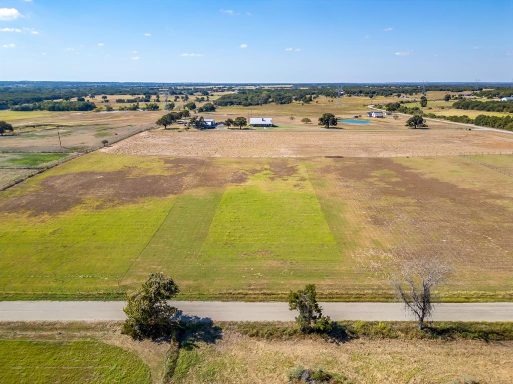 One of four beautiful 2-acre lots available in a row in Poolville, offering the perfect opportunity to build your dream home in peaceful Parker County. These level tracts provide a clean slate for your custom build, whether you envision a traditional home or a barndominium. Horses are welcome, giving you the flexibility to create the country lifestyle you’ve been wanting. Fully fenced. Located outside the city limits, you’ll enjoy fewer restrictions and wide-open space, while still being conveniently positioned just about 30 minutes from Fort Worth and Weatherford. Enjoy the quiet of rural living without sacrificing access to shopping, dining, and major highways. Buy one lot or secure both for additional space and privacy. Opportunities like this are hard to find, come walk the property and start planning your future today. All information is deemed reliable but not guaranteed. All information is deemed reliable but not guaranteed. Buyer and Buyer’s Agent to independently verify all information, including dimensions, acreage, utilities, restrictions, rollback taxes, floodplain status, schools, easements, and mineral rights.