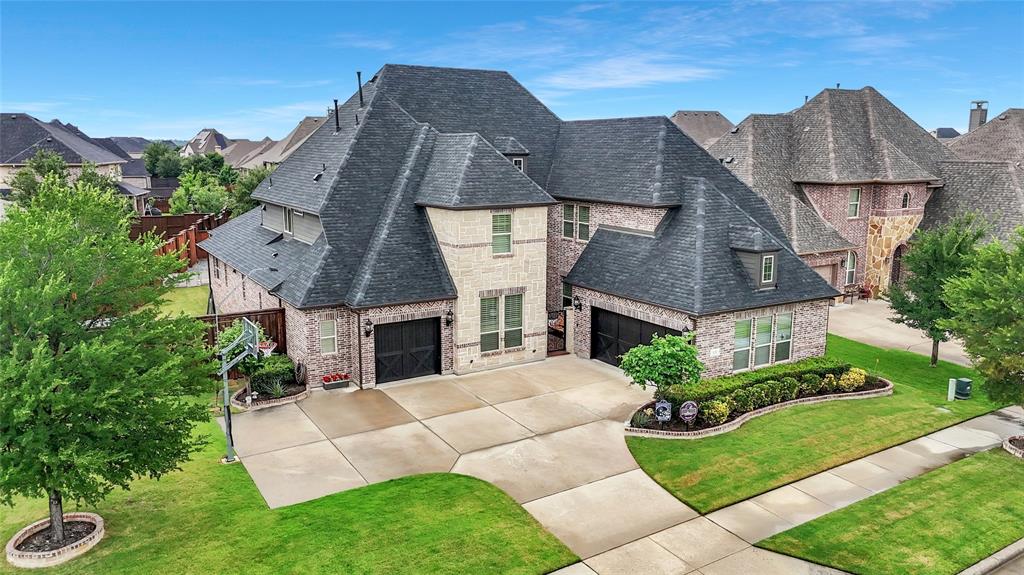 Custom Darling home in Prosper ISD featuring 4 spacious bedrooms, each with its own private bath, a dedicated home office, first-floor media room, upstairs game room, massive storage room, oversized 3.5-car garage space, and private first-floor guest suite ideal for visitors or multigenerational living. Upgraded finishes are showcased throughout, including hand-scraped hardwood floors, shutters, and soaring two-story ceilings in the family room that fill the home with natural light. The chef’s kitchen is truly the heart of the home, complete with an oversized island and breakfast bar, extensive cabinetry and prep space, a 6-burner gas cooktop, soft close drawers and double ovens, and enlarged pantry. Retreat to the luxurious primary suite featuring a beautiful bay window sitting area, spa-inspired bath, and an expansive walk-in closet with convenient direct access to the utility room for added functionality and ease. Private backyard oasis features a 34x14 Hauk pool added in Summer 2024, and custom outdoor patio with built-in grill and 2 side burners on a 14' granite counter! Recent upgrades include a fire suppression system throughout the entire home, air duct and dryer vent cleaning in April 2026, new level 4 roof installed in June 2024, new TRANE AC unit for upstairs installed September 2025, reverse osmosis kitchen faucet installed April 2026, water softener throughout the entire home, and EV charger in the garage. Located in the highly sought-after Windsong Ranch community, residents can enjoy access to the stunning lagoon, clubhouse, community pools, miles of scenic trails, fishing pond with dock, fitness center, pickleball and tennis courts, and SO much more!