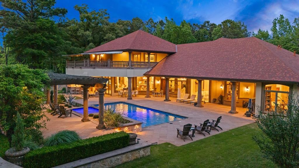 Welcome to Casa Cantera, an extraordinary luxury retreat nestled on 3 pristine acres in North Longview’s prestigious Champions Ridge Estates, with direct access to Crossing Creeks Golf Course and Country Club. This Mediterranean masterpiece blends timeless architecture, privacy, and natural beauty with impeccable craftsmanship throughout.

The main-level primary suite is a true sanctuary, featuring dual baths, separate his-and-hers closets, and serene views of the resort-style backyard. With 5 bedrooms, 4.5 baths, a private office with built-ins, and multiple living spaces, the home seamlessly combines elegance and functionality.

A private gated entrance, rod iron fencing, and lush landscaping set the stage for the grand 10-foot iron double doors, opening to interiors with polished marble floors, 2”x6” construction, and a reinforced foundation with over 50 piers. Electric shades enhance comfort and ambiance throughout.

Designed for entertaining, the home offers a stunning great room with fireplace, wet bar, and wine cellar with its own HVAC system. The chef’s kitchen features top-of-the-line Thermador appliances, complemented by a whole-home water filtration system, central vacuum, and spray foam insulation for efficiency.

Outdoor living is unmatched with a sparkling pool, expansive pergola with fireplace, full outdoor kitchen, and gas patio heaters for year-round enjoyment. Copper gutters and mature trees enhance the estate’s beauty and privacy.

Additional features include a 22KW generator, three tankless water heaters, heated floors in downstairs baths, a 4-car garage with epoxy finish, and a 400 SF climate-controlled storage building. Imported Cantera stone and limestone accents, a new Class III roof (2026), cedar trim, security system, and a dedicated HVAC dog room complete this exceptional property.

Casa Cantera is more than a home—it’s a statement of luxury living.