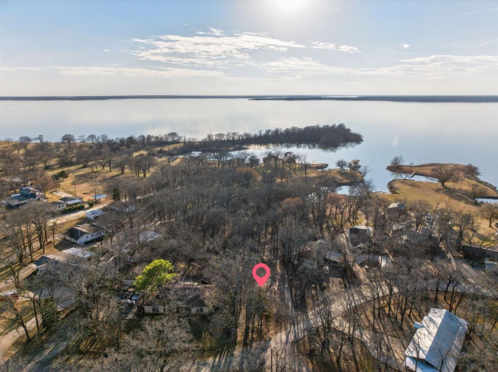Bring your vision and start building your future on this waterfront lot on Lake Tawakoni. Located in East Tawakoni, 594 Briggs Blvd sits in the quiet and established lakeside community, Whispering Oaks, in Rains County.  This vacant parcel offers an excellent opportunity for a custom home, weekend retreat, or investment build.  The SRA permitted area is just the right amount of space for any outdoor activity. Just down Briggs Blvd, you will find a community park and boat ramp. Lake Tawakoni is about 60 miles east of Dallas and is a favorite for weekday and weekend fishing and boating.  It is known for excellent fishing for catfish, as well as bass and hybroids. NO HOA!  Sunset views! Come and take a look!