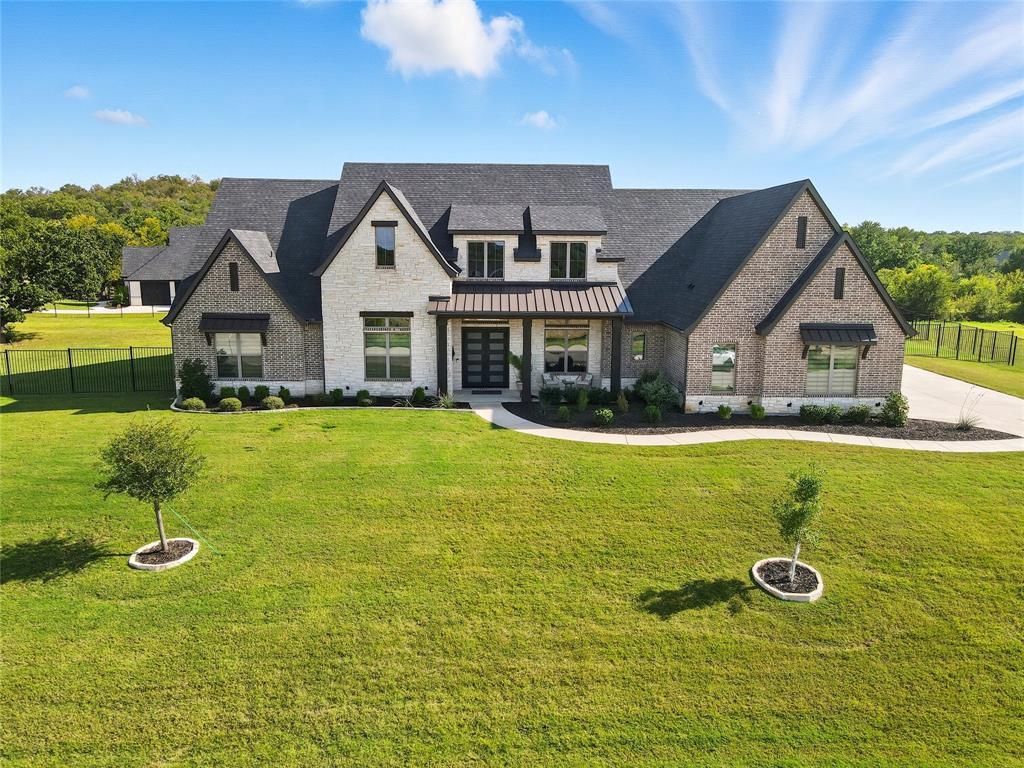 CUSTOM SINGLE STORY 1+ ACRE ESTATE with a 4 CAR GARAGE & UNBEATABLE BACKYARD IN PRESTIGIOUS MONTALCINO ESTATES! Sophisticated luxury meets timeless craftsmanship in this sprawling single-story featuring extensive wood floors, top-of-the-line Pella sliding patio doors, crown molding, decorative lighting & an open-concept floor plan, plus built-in speakers in the family room, primary bedroom & patio. Elevate your culinary game in the thoughtfully designed kitchen boasting quartz & granite counters, under cabinet lighting, large walk-in pantry, farm sink & high-end appliances including a built-in refrigerator & Wolf double ovens & 48 in range top with a griddle. Enjoy gatherings in the impressive family room showcasing a floor-to-ceiling stone fireplace & wood-beamed cathedral ceiling, or work from home in the office graced with French doors & an accent wall. Tucked away at the back of the home, the lavish primary suite boasts an oversized walk-in shower, freestanding tub, separate granite vanities &  massive walk-in closet with built-ins. Just off the primary suite, a versatile flex space offers the perfect spot for a home gym, 2nd office, nursery, or sitting area—whatever suits your lifestyle best. A private guest suite connects to the rear garage with its own entrance, providing ideal accommodations for multigenerational living or guests. Spend time with friends & family in the game room with a snack bar, or watch movies in the secluded media room featuring sliding barn doors, dimmable lighting, surround sound & an equipment closet. Paradise awaits you in the incredible backyard where you can cool off in the PebbleTec pool & spa with tanning ledge lounge chairs, improve your golf game on the putting green, unwind in the outdoor living area with a fireplace or host get-togethers in the cabana with an outdoor kitchen. Montalcino amenities include a gated entrance, clubhouse, pool, fitness center, pickleball, tennis, trails & scenic lake. Attends top-rated Argyle ISD!