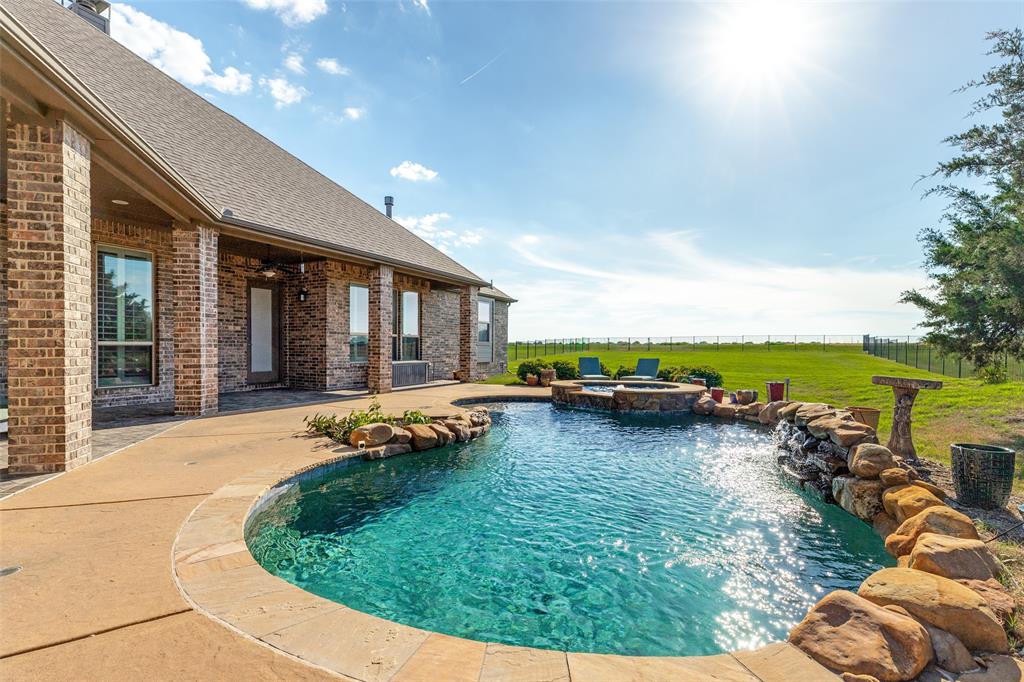 Exquisite Single-Story Retreat on Over an Acre in Award-Winning Allen ISD

Experience refined living in this stunning 4-bedroom, 4-bath luxury home perfectly designed for comfort, style, and entertaining. The open-concept layout showcases exotic hardwood floors, soaring exposed beams, and elegant finishes throughout. The gourmet kitchen is a chef’s dream, featuring a 6-burner gas stove with pot filler, premium appliances, and an expansive island ideal for gathering. A double-sided fireplace warms both the spacious primary bedroom and its serene sitting area, creating a relaxing retreat.
Step outside to a backyard oasis complete with a sparkling pool, outdoor kitchen, and generous patio—perfect for hosting or unwinding in complete privacy. A full MIL ensuite provides ideal accommodations for guests or multigenerational living.
Set on over an acre of beautifully landscaped grounds and located in the award-winning Allen School District, this home blends sophistication, functionality, and resort-style living in every detail.