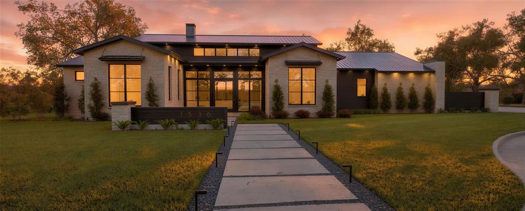 Experience refined luxury in this single-story modern contemporary home by Eclipse Custom Homes, where exceptional craftsmanship and thoughtful design are showcased. Featuring premium stone stucco paired with high-end composite cladding and a custom pivot door, this residence makes an unforgettable first impression. Wood flooring flows throughout the open-concept layout, designed for both comfortable everyday living and seamless entertaining. A private office provides a sophisticated workspace, while the living room is anchored by a sleek linear gas fireplace. The kitchen is outfitted with premium Thermador appliances, an oversized island with breakfast bar, a built-in refrigerator, gas range, and a separate prep kitchen for added convenience and functionality. Weather Shield wood windows enhance the home’s architectural character while bringing in abundant natural light. Kohler Purist plumbing fixtures elevate both the kitchen and baths with timeless, modern elegance. Sliding glass doors open to a large covered patio with a grilling area, creating effortless indoor-outdoor living ideal for year-round gatherings. Each bedroom is a private retreat, offering its own en suite bath and walk-in closet. The luxurious primary suite is a true sanctuary, featuring a sitting area, direct patio access, and a convenient connection to the laundry room. The spa-inspired primary bath delivers a serene escape with a freestanding soaking tub and elegant designer finishes. Designed with entertaining in mind, the Gameroom includes a wet bar and opens directly to the outdoor living space.  Premium materials—including quartz, quartzite, and granite countertops—are beautifully incorporated throughout the home. The backyard oasis is complete with an outdoor fireplace, creating the perfect setting for relaxing or entertaining under the open sky. Enhanced with luxury finishes and designer selections throughout, this home offers an elevated living experience with attention to every detail!