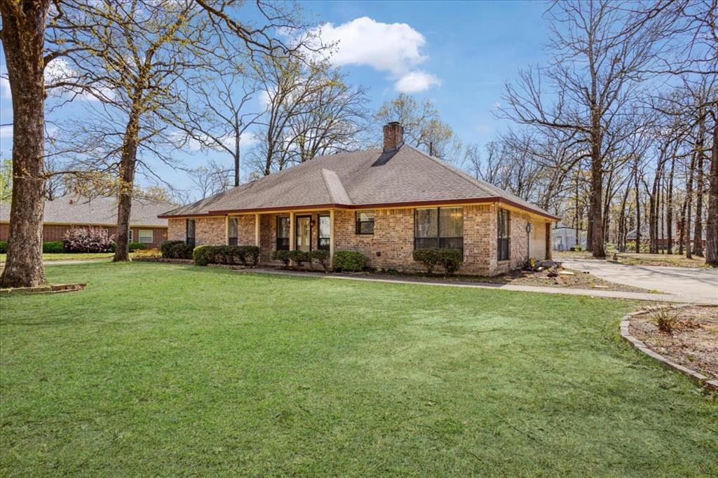 Discover this beautiful home situated in a tranquil Powderly neighborhood.  The entry welcomes guests and loved ones into a splendid living area, open to the kitchen, with a stately fireplace and striking tray ceiling with wood slat inlay.  The kitchen offers abundant counter space with bar seating, ample cabinet storage, a two-basin stainless sink, and a sunlit dining area adjacent.  A second living area at the rear of the home offers even more space to relax and entertain, complete with a convenient wet bar.  The primary bedroom is spacious and includes a fabulous en suite bath with dual vanities and a generous closet with built-in shelving.  Out back, enjoy a covered patio and extended stone terrace along with plenty of space for recreation beneath the shade of mature trees.  Additionally, the backyard offers a large workshop with electrical power, a concrete apron, and oversized sliding doors.  Easy access to Hwy 271 and just minutes from a full array of city amenities in Paris.  Nearby 6,000-acre Pat Mayse Lake with fishing, boating, hiking, and camping. Refrigerator, Washer & Dryer to convey with property. Fiber Internet available in Beaver Creek with AT&T!