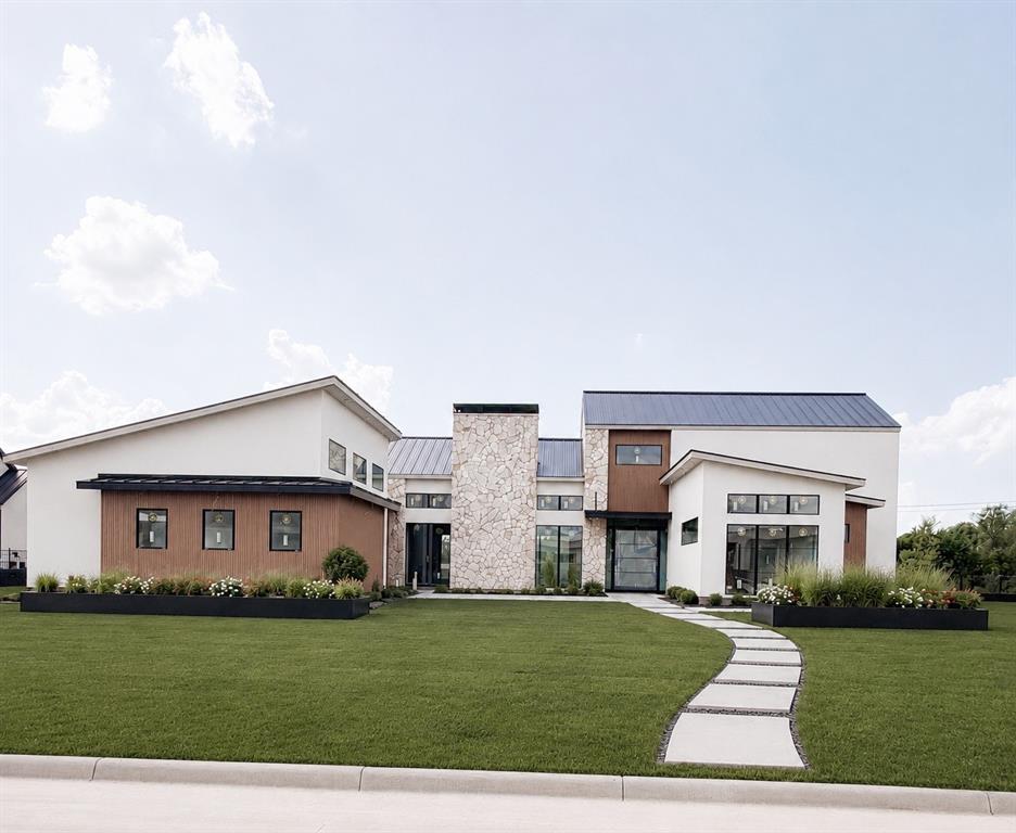 Imagine waking each morning in one of Heath's most exclusive luxury communities, where winding trails, private lakes, rolling landscapes, and estate-sized homesites create a peaceful retreat from the pace of everyday life. Nestled within the prestigious Ridge Lakes of Heath, this extraordinary custom built residence offers the rare combination of refined architecture, superior construction, and resort-style living.

Spanning 5,407 square feet, this stunning estate features 5 spacious bedrooms, 6 luxurious baths, a private sauna, and a 4-car garage, all thoughtfully designed for both grand entertaining and everyday comfort. Set on a Beautiful homesite, the property offers the privacy and space that luxury buyers desire while remaining just minutes from Lake Ray Hubbard, premier dining, shopping, and highly acclaimed Rockwall Heath ISD schools.

The heart of the home is a breathtaking living room where timeless elegance meets modern sophistication. Rich natural white oak flooring grounds the space with warmth and character, while imported Vista Maya stone from Tulum, Mexico, creates a stunning architectural backdrop that feels both refined and organic. A dramatic 72-inch fireplace serves as the focal point of the room, blending contemporary design with the inviting ambiance of a traditional gathering space.

Step outside to expansive outdoor living spaces complete with a built-in grill and a pool-ready backyard designed to become your own private resort. Whether hosting family and friends beneath the stars or enjoying a quiet evening overlooking your estate property, this home was built to elevate every moment.

More than a home, this is a lifestyle defined by luxury, privacy, craftsmanship, and the unmatched beauty of Ridge Lakes of Heath one of North Texas' most coveted custom-home communities.