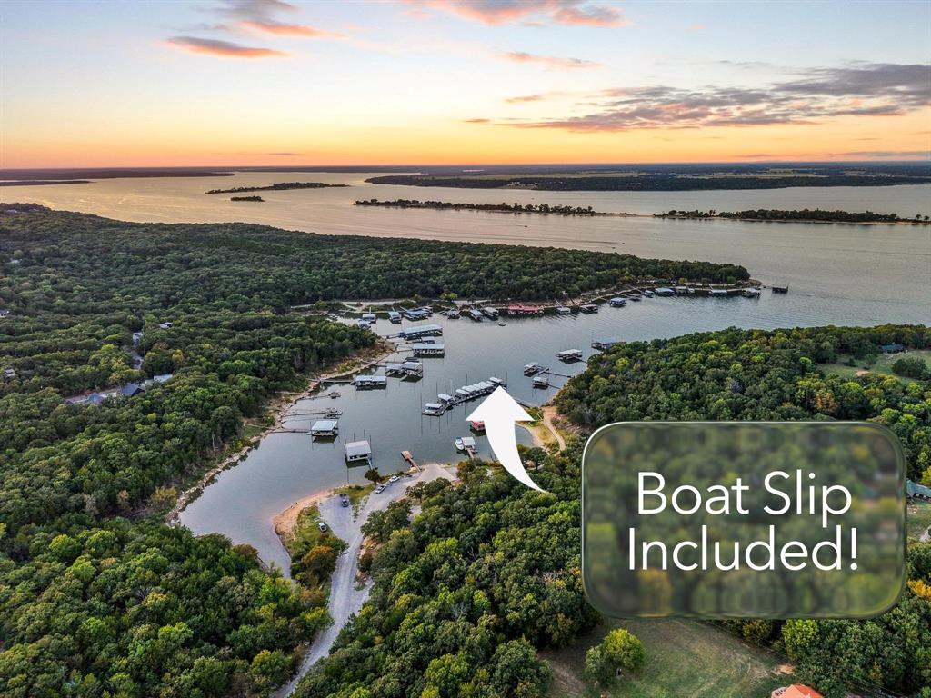AMAZING LAKE PROPERTY WITH BOAT SLIP! LAKE TEXOMA WATERFRONT COMMUNITY! Discover your dream getaway at this idyllic lakehouse nestled in the waterfront Cambridge Shores community that overlooks the renowned Islands of Lake Texoma. Imagine hopping on your golf cart and arriving at your BOAT SLIP in 2 minutes. Be on the water quickly! A boat is available for purchase, too. This property offers not just a home, but a lifestyle immersed in lake living. Situated on a generous 1.27-acre lot, this modern design seamlessly blends contemporary aesthetics with natural surroundings. Originally built in 1984, the home has undergone a meticulous transformation, stripped down to the studs and thoughtfully rebuilt in 2022. As you step inside, you'll be greeted by beautiful finishes that enhance the open-concept layout, allowing for an effortless flow between living spaces. The roofline windows invite an abundance of natural light. Step outside onto the double wrap-around covered decks—perfect for entertaining guests and relaxing. The solid construction features durable fiberboard siding topped with a sturdy metal roof, ensuring your investment stands the test of time. Spray-foam-insulated walls and an attic create an energy-efficient environment. The property includes a detached garage with electricity and a second concrete driveway, providing ample parking and storage. A fenced yard provides security and privacy, while the firepit area is an ideal spot to gather. Mature, plentiful trees create a serene oasis where you can unwind. This lakehouse isn't just a beautiful retreat; it's an ideal investment opportunity. With the potential to add additional units, you can tap into lucrative short-term rental income. Conveniently located near Highport Marina and Tanglewood Resort & Golf Course. NEW INTEREST RATE BUY-DOWN INCENTIVE OFFERED BY THE SELLER! RATE AS LOW AS 4.75%! See listing photo for more details. Embrace the allure of lake life—MAKE SUMMER 2026 EPIC!