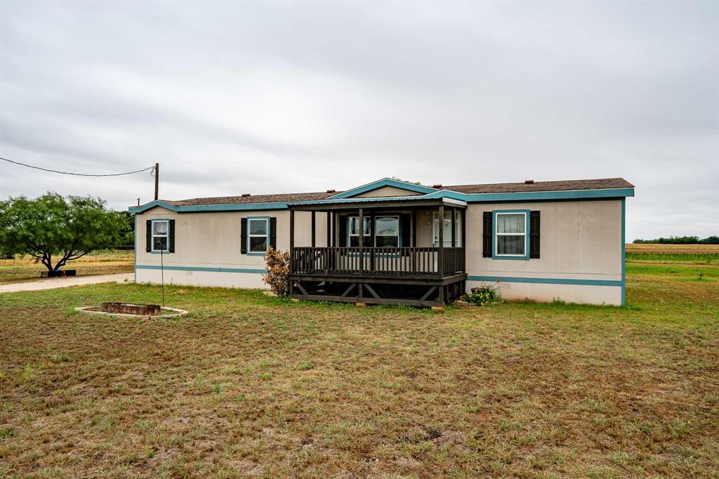 Just outside of Hawley and only a short drive to Abilene, this 2004 Palm Harbor manufactured home offers peaceful country living on 3 acres with room to enjoy the outdoors. Featuring 3 bedrooms, 2 bathrooms, and a second living area, the layout provides flexibility for entertaining, a game room, office space, or additional family room. Recent improvements include new vinyl flooring throughout the common areas, a brand new central heat and AC unit, new water heater, and a newly built front deck perfect for relaxing and enjoying the quiet surroundings. The chicken coop and storage building will both convey with the property, adding even more value and functionality. If you have been searching for affordable country living with modern updates and convenient access to town, this property is one you will want to see. The home was placed on the property in 2019.