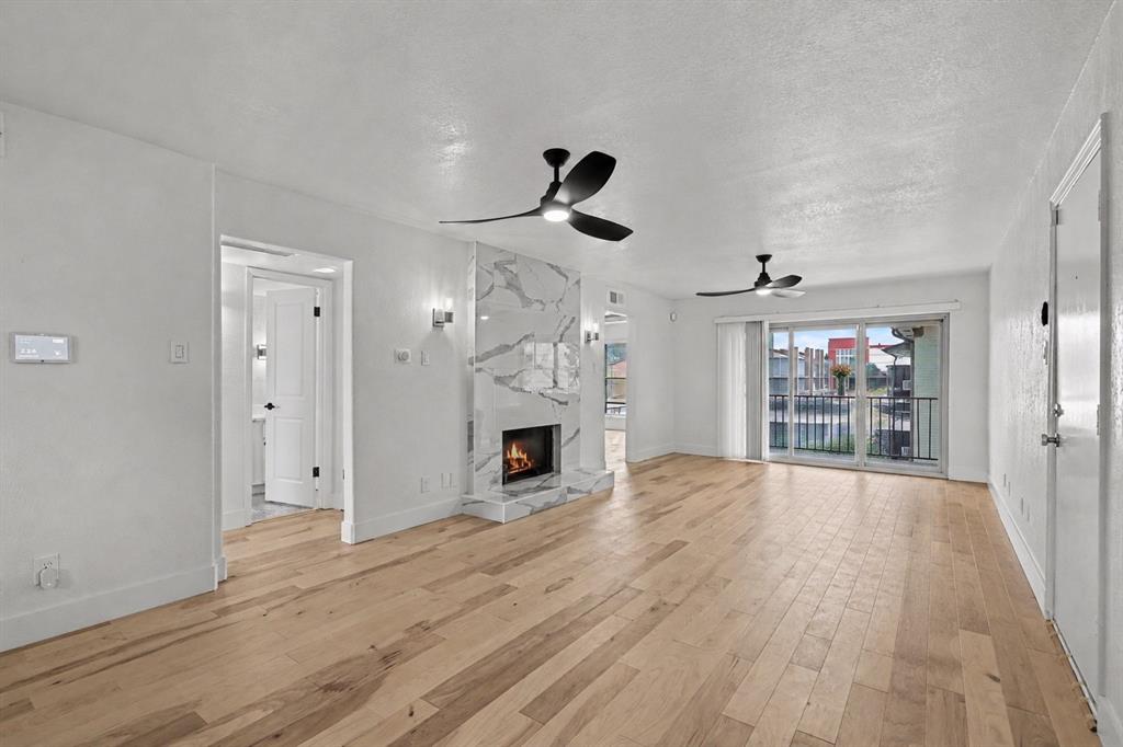 Fully renovated and absolutely stunning condo at One Steppington Place is unlike anything else in the building. Every inch has been thoughtfully transformed with high end finishes that deliver a level of sophistication you simply don't expect at this price point in North Dallas.

From the moment you walk in, the wood floors, open layout, and living room fireplace set a warm and stylish tone. The kitchen is a designer's dream with beautiful blue cabinetry, exposed shelving that brings a modern editorial flair, beveled subway tile backsplash, quartz countertops, and new KitchenAid appliances including a dishwasher and induction oven. The galley style layout maximizes every inch of space beautifully. Both bathrooms feature floor-to-ceiling marble, a luxury detail that elevates the entire home. The primary suite has a private ensuite bath, and the secondary bedroom has direct access to the hallway bathroom. The secondary bedroom also features a spacious closet. A generously sized in-unit laundry room with full-size washer and dryer that convey adds everyday convenience that buyers always appreciate. The balcony off the living room is the perfect outdoor escape. New energy efficient windows throughout and an ADT alarm system round out this impeccably finished condo.

One Steppington Place is a gated community featuring a pool, clubhouse, shaded seating areas, and assigned covered parking. Easy access to Hwy 75 and I-635 puts Downtown Dallas just minutes away. NorthPark Center, Topgolf, the Shops at Park Lane, SMU, and Dallas Love Field are all just a short drive away. Anderson Bonner Park and White Rock Creek Trail are nearby for outdoor recreation. Zoned to Dallas ISD.

Come tour it! Fully renovated condos with marble bathrooms and designer kitchens in this location don't come available often!

Discounted rate options and no lender fee future refinancing may be available for qualified buyers of this home.