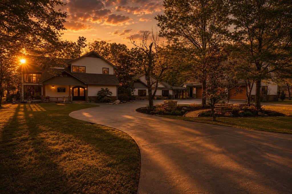Opportunities like this are incredibly rare-an expansive, private estate set on nearly six wooded acres in the prestigious gated Lake Fork Country Club Estates. This one-of-a-kind property offers seclusion, space, and lifestyle, just minutes from Emory and within easy reach of Tyler and Dallas.

Encompassing just under 5,300 square feet of living space across six lots-many with frontage on a private stocked pond-this property delivers a truly unmatched setting. The community features an 18-hole golf course, private boat ramp, and emergency helicopter access. Even more impressive, the total tax rate is just 1.1447%, offering exceptional long-term value for a property of this scale

Inside, soaring vaulted ceilings, a floor-to-ceiling wood-burning fireplace, skylights, and walls of glass create a bright, inviting atmosphere. The open living and kitchen area overlooks the pond and features stainless steel appliances, granite countertops, pendant lighting, antique pressed-tin ceiling detail, abundant cabinetry, and a breakfast bar. A Ring security system adds peace of mind.

The flexible floor plan includes 5 bedrooms, 4 full baths, and 2 half baths. The main level offers 4 bedrooms and 3 baths, including a private guest suite and Jack-and-Jill layout. The upstairs loft serves as a fifth bedroom or office with its own bath and closet.

The primary suite features a fireplace, built-ins, and a spa-style bath with jetted tub, glass-block shower, and walk-in closet. Above the three-car garage, a nearly 1,100-square-foot bonus room-accessible by stairs or elevator-creates the perfect space for entertaining, a game room, or multi-generational living.

Outdoors, enjoy a covered patio, walking trail with bridges and gazebo, and abundant wildlife. Fish in your backyard or enjoy world-class fishing just minutes away on the 27,000-acre Lake Fork, renowned for trophy bass fishing. With golf just beyond your property line, this is a rare opportunity you don’t want to miss.