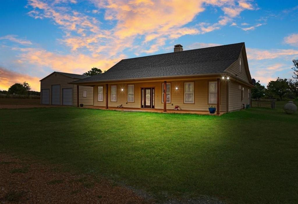 Presenting 7944 CR 669, Blue Ridge, TX USA. the perfect combination of a modern Texas farmhouse, on 5.24 acres, with NO Deed Restrictions, complete with a 30x30 workshop and a big tank. Location is important and you are positioned in Blue Ridge ISD, between Farmersville and Blue Ridge, close to State Highway 78, and an easy commute into the Sherman technology corridor, McKinney or DFW. Step inside to the expansive vaulted ceilings, showcasing wood rafters and a central brick fireplace. Yes, it's hot outside today, but you will appreciate the easy to use gas fireplace come winter. Turn the corner and relax in the massive primary bedroom, complete with an ensuite bathroom, offering a whirlpool tub, dual copper sinks and a walk-in custom shower. The kitchen showcases a copper farm sink, generous cabinets, wood counters and a gas stove. The second bedroom is a suite with access to the adjacent bathroom. Since the home is one and a half stories, you can escape upstairs to the secluded third bedroom. You will appreciate the spray foam insulated walls, a tankless hot water system and an attic with wood floors for extra storage. The recently built 30x30 workshop, on a concrete pad, with roll-up doors, is ready for your truck, tractor and side-by-side. Step outside onto the oversized front and back porches, enjoy the cooking shed and fenced backyard. The picture- perfect land is perimeter fenced on three sides, and boasts a nearly half acre stocked pond. So, bring your fishing pole. Your cows will love it here. You don't have a cow, well, maybe you need one.  NO Deed Restrictions. NO Floodplain. The desirable Wilson Clay and Crocket Soils are rated for grazing through limited farming. Information is deemed reliable but Buyer should perform due diligence.