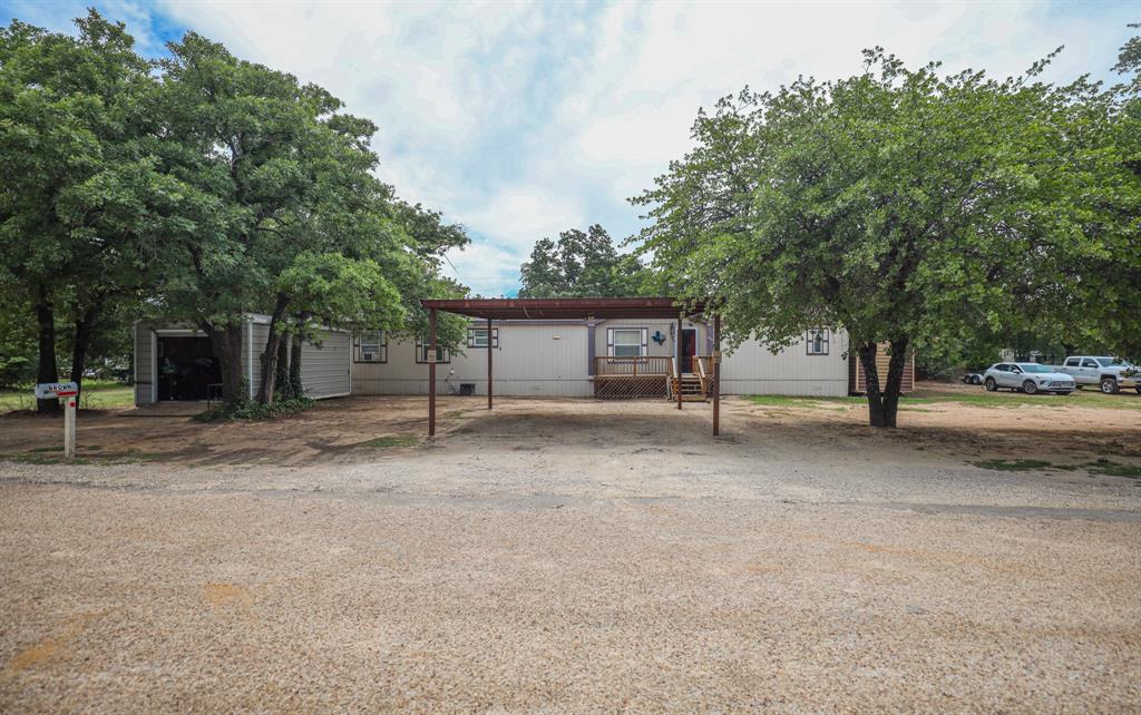 Now including additional 0.208 acre lot so total of 0.478 acres ! Tired of the increasing cost of rent? Here is the perfect opportunity to escape your landlord & have your own equity! This inviting Clyde home offers an open-concept design that provides a modern living experience tailored for those who value space and functionality. Step inside to be greeted by freshly painted walls that enhance the spaciousness of the open living areas. The seamless flow from the living room to the kitchen and dining areas makes for an ideal setting for both relaxation and entertaining. The kitchen is a central hub, ready for culinary adventures and gathering with loved ones.
The home's three bedrooms and split floor plan, offer privacy and comfort, with the primary suite offering a peaceful retreat complete with an en-suite bathroom and garden tub. Outside, the luscious landscape features beautiful pear and oak trees, creating a serene setting that invites you to enjoy the outdoors. While there is no garage, there is a carport and two sheds with electricity, one that is also spray foamed perfect for all your workshop or craft needs. The expansive grounds offer plenty of potential for gardening, play, or simply basking in the Texas sunshine. This charming home combines modern updates with classic comforts, offering a delightful living space in a welcoming community. Stroll through the inviting grounds, savor the serene natural surroundings, and explore the potential that this Clyde residence has to offer.