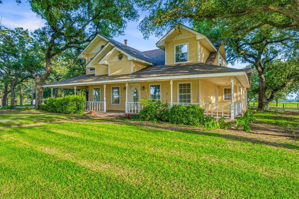 Set on just over an acre in a highly desirable location just outside of town, this spacious farmhouse offers over 3,000 square feet of living space with character, generous room sizes, and a floor plan designed for comfortable everyday living. The inviting wraparound porch creates a welcoming first impression and provides the perfect place to enjoy the surrounding countryside views.
Inside, the large kitchen serves as the heart of the home, featuring granite countertops, a center island, updated backsplash, abundant cabinetry, and an open flow into the second living area and sunroom. Tall ceilings in the kitchen and expansive windows fill these spaces with natural light.
With four bedrooms, three full bathrooms, and two separate living areas, the home offers exceptional flexibility and functionality. The primary suite includes a cozy fireplace, adding warmth and character to the private retreat. Spacious secondary bedrooms, large common areas, and thoughtful storage options throughout the home provide room to spread out. The sunroom offers a bright additional gathering space overlooking the property, while the outdoor storage building provides extra room for equipment, hobbies, or seasonal items. Mature trees, open space, and a convenient location combine to create a property that is increasingly difficult to find.
With solid bones, an attractive layout, and endless potential for personalization, this property presents a rare opportunity to enjoy country living with the convenience of town just minutes away. A home filled with space, charm, and possibilities, ready for its next chapter.