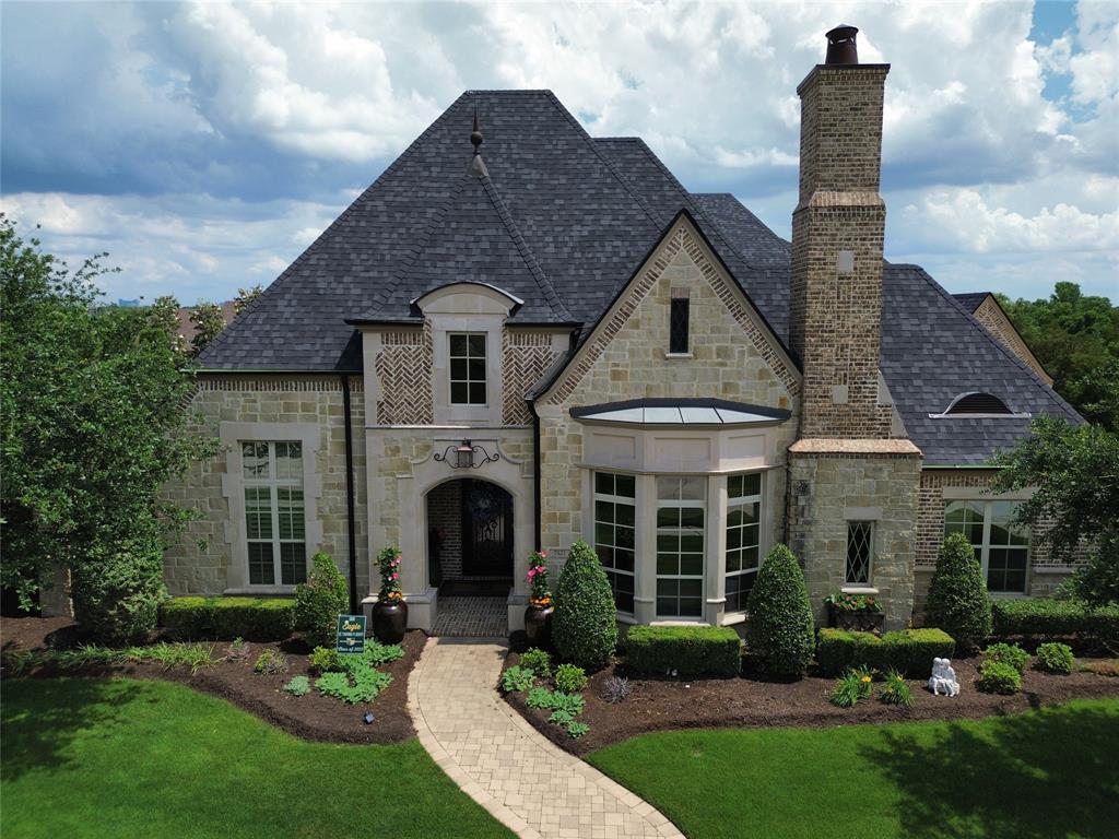 Kingsbarns: Where Luxury Meets Lake & Green
Reign supreme in The Tribute's most coveted domain: 7421 Kingsbarns. This Sanders-crafted masterpiece, nestled within the gated village of Balmerino, sprawls across a massive  lot, embracing both shimmering Lake Lewisville and the emerald golf course.Step inside to opulence: Double staircases gracefully ascend, adorned with wrought-iron detailing that hints at the grandeur within. A Sub-Zero refrigerator hums amidst expansive butler's pantries, promising effortless entertaining.
 Private boat garage, infinity pool with rock slide, & sprawling lot. Outdoor fireplace & kitchen sizzle beneath starry skies. All of this and so much more, this home is a rare find. Live extraordinary. Claim your paradise.