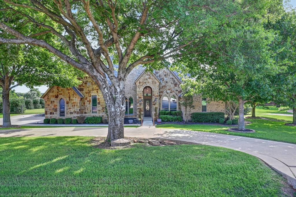 This is an absolutely stunning country home with so much to offer. The primary bedroom features an exterior door to walk out to the pool, large en-suite with separate vanities, a jetted tub and large walk-in shower. Additional bedrooms are on the opposite side of the house and share a Jack and Jill bathroom. The open kitchen has beautiful granite counters, island, eat up counters, stainless appliances and gas stove top. The living room features a gas fireplace and gorgeous, brand new handscraped hardwood floors. The office has built-in cabinets and desk, french doors and new handscraped hardwood floors. The game room or media room includes a dry bar and a large walk-in closet. Take a step out back to find an incredible infinity edge pool with beach walk in, fire pits with eye-catching blue broken glass, fountains and a wonderful covered outdoor kitchen with brand new gas grill and refrigerator. Past the infinity pool you'll find one seating seating area around another fire pit and a second seating area perfect for gatherings of all kinds or quiet days and nights relaxing. All of this on a beautifully manicured acre of land that sits on a quiet cul-de-sac. No HOA. No city taxes. Total tax rate of 1.701