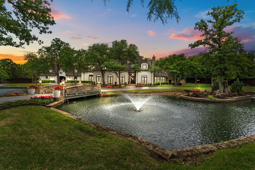 Welcome to Luxury Living at 1100 La Paloma Court in Southlake, TX. Nestled at the end of a cul-de-sac within the exclusive gated community of Lakes of La Paloma, this extensively remodeled custom estate is a true architectural masterpiece, boasting bespoke design elements throughout. Spanning 7,673 sq ft on a 1.38-acre waterfront lot, this home offers an exquisite blend of luxury & privacy. The spacious floor plan incl 5 beds, 5 full baths, & 3 half baths. An oversized bedroom w ensuite on the 2nd floor could serve as a 2nd primary suite. The 5th bed functions as guest room, w a full bath & accessible via a sep entrance above the 4-car garage or from inside the home. The residence offers 3 living areas, a private study, & a game-media room, complemented by a formal dining area w a combo butler’s pantry & wine room. Whether hosting large or intimate soirées, the expansive living room w a fireplace & water views provides the perfect ambiance. Culinary enthusiasts will adore the chef’s kitchen, featuring top-of-the-line appliances, granite counters, a breakfast bar, & extensive workspace. The primary bedroom suite is a serene retreat, offering a sitting room & a luxurious ensuite w sep vanities, a massive walk-in closet, sep toilets, a freestanding tub overlooking a rock waterfall, & private courtyard access. The bright, airy interior seamlessly flows into an outdoor oasis, where an oversized covered patio w a grill, fireplace, pool w a rock waterfall, spa, dog run, & a fire pit await, creating the ideal setting for outdoor gatherings. Begin your day w a tranquil coffee waterside, surrounded by the sights & sounds of nature. This remodeled estate delivers an unparalleled living experience, blending elegance, comfort, serenity, & modern convenience in a highly sought-after location. Enjoy proximity to local amenities like Central Market & Southlake Town Square, all within a short walking distance. Embrace the luxurious lifestyle offered by this extraordinary estate.