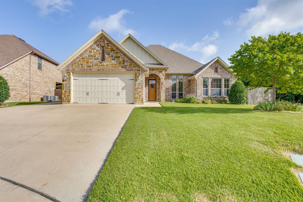 Welcome to this beautifully crafted home nestled in the highly desirable Mountain Valley subdivision and located within sought after Joshua ISD! Offering 3 bedrooms and 2 bathrooms, this meticulously maintained residence combines quality craftsmanship, thoughtful design, and exceptional functionality.  Step inside to discover rich hardwood flooring, wide baseboards, and elegant crown molding throughout, creating a warm and sophisticated atmosphere. The open concept floorplan seamlessly connects the spacious living area and kitchen, making it ideal for both everyday living and entertaining. Gather around the inviting fireplace featuring gas logs with natural gas and custom built ins that add both charm and storage.  The chef's kitchen is sure to impress with custom cabinetry, granite countertops, stainless steel appliances, a gas cooktop with pot filler, wall oven, walk-in pantry, and a large island topped with a beautiful butcher block countertop.  Retreat to the private primary suite, complete with a thoughtfully designed closet featuring built in drawers for optimal organization. The ensuite bathroom offers double vanities, granite countertops, abundant storage, and a spacious walk in shower.  Additional highlights include an oversized utility room with extensive cabinetry, granite countertops, and a built-in ironing board for added convenience. Safety and peace of mind are provided with a steel safe room measuring approximately 4 ft 7 in x 4 ft 6 in.  Step outside to enjoy the large covered patios overlooking a beautifully landscaped backyard featuring a charming garden arch and tranquil pond with pump creating the perfect outdoor oasis for relaxing or entertaining.  This exceptional home offers the perfect blend of comfort, style, and functionality in one of the area's most desirable communities.