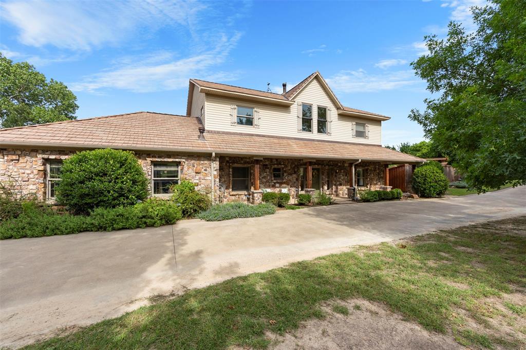 No city taxes!Over 3 acres of everything imaginable! Pool, pond, space for animals, amazing shop, private well, guest quarters, all in the Aledo ISD! Built and cherished by a one owner family,this extraordinary property is more than a home—it’s a legacy. Rich in history and craftsmanship, this remarkable residence is a true testament to its architectural distinction and enduring qualityThis stunning two-story home showcases breathtaking features throughout the interior, blending rustic elegance with timeless designA wood-burning stove beautifully connects the kitchen and living room, creating warmth and ambiance at the heart of the home. The spacious primary suite upstairs offers a peaceful retreat complete with a private ensuite bath while an optional SECONDARY primary suite on the main floor—also with a full ensuite bath—provides flexibility for guests or multi-generational living.Step outside to your own private oasis featuring an outdoor pool surrounded by an expansive stone-laid patio. Two pergolas both enhance the outdoor living experience—one poolside and another on the back porch overlooking a serene seasonal pond.For all those who enjoy a shop that has it all-includes a large hand built wood stove and 4 mini splits keeping it nice and cool or warm for all seasons working on those projects.also entails a glassed porch area overlooking the property;Upstairs is a full guest quarters consisting of 2 bedrooms, a full bathroom, bath-shower combo;downstairs includes an additional full bath with shower, and full sized washer-dryer area. The second shop, another area with plenty of space to work on automobiles or projects,comes with plenty of storage. This property includes 3 large solar panels,totally paid for, that result in very attractive utility bills throughout the year. The list goes on and the features are endless in this home!
