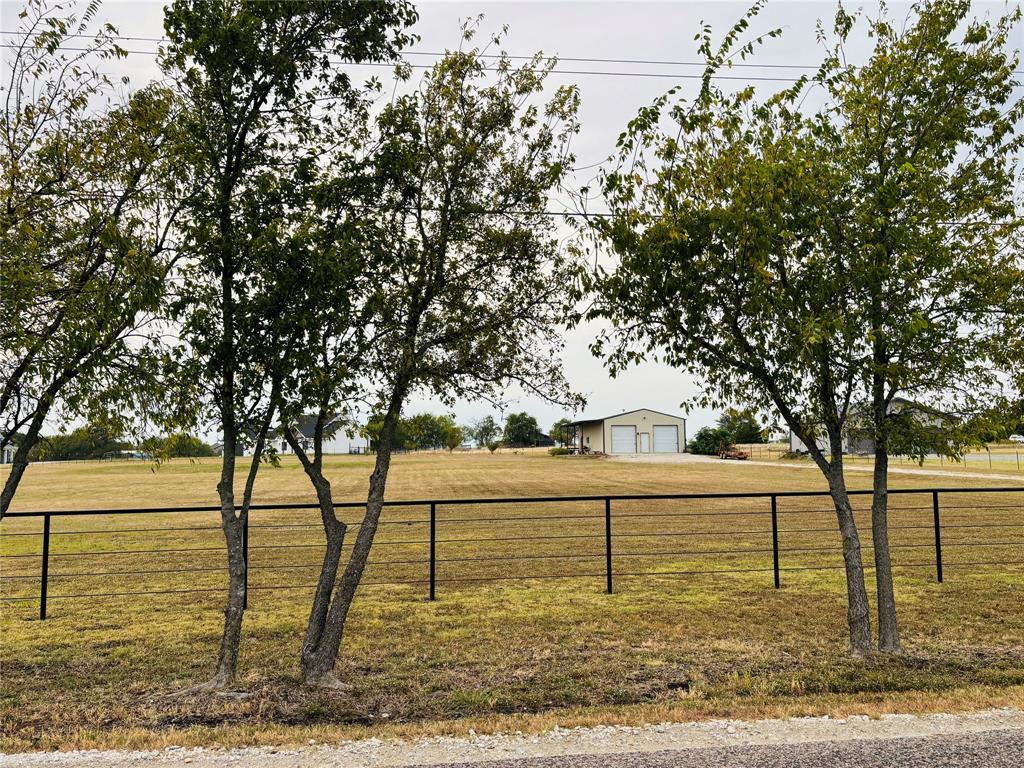 ~ BEAUTIFUL 2 ACRE IMPROVED PROPERTY READY TO BUILD ~ WITH 30x50 METAL WORKSHOP & LIVING QUARTERS!  This Well Prepared 2-acre Tract Offers an Outstanding Opportunity for Investors, Builders, or Anyone Ready to Create their Dream Property. Featuring a 30x50 Metal Workshop Constructed in 2021, This Site is Already Equipped with Essential Infrastructure — Electricity, Water, and Septic System Installed — Saving Both Time and Expense! The 1,500 sq. ft. WorkShop is Fully Insulated with Two Overhead Doors and Includes approx. 850 sq. ft. of Finished Living Space Featuring a Living and Kitchen Area, Two Bedrooms, and One Full Bath. Interior Finishes Include Stained Concrete Floors & Granite Countertops. The Layout is Ideal for Temporary Housing During New Construction, or Serve as Guest Quarters, an Office, or Rental in the Future. Additional Property Improvements Include: Custom Iron Entry, Pipe and Cable Fencing Along Frontage and Barbed Wire Fencing on the Remaining 3 Sides. The Property also Features Mature Native Trees Across the Front & Several Fruit Trees have been Planted Along the Back. Enjoy Relaxing Outdoors under the Large Covered Patio Surrounded by Planting Beds. Site Prep and Grading have Already Been Completed for Proper Drainage, Making this Property Truly Build Ready! 
No HOA Fees or Restrictions!! The Location is Outside Gunter City Limits, therefore You’ll Benefit from Lower Property Taxes and Flexible Building Options! Convenient Location Just minutes from Preston Road aka TX-289 and Downtown Gunter, & the Planned Dallas North Tollway Expansion, Positioning this Property for Strong Future Growth and Appreciation. Bring your Plans and Builder — This Property is Ready To Go!
