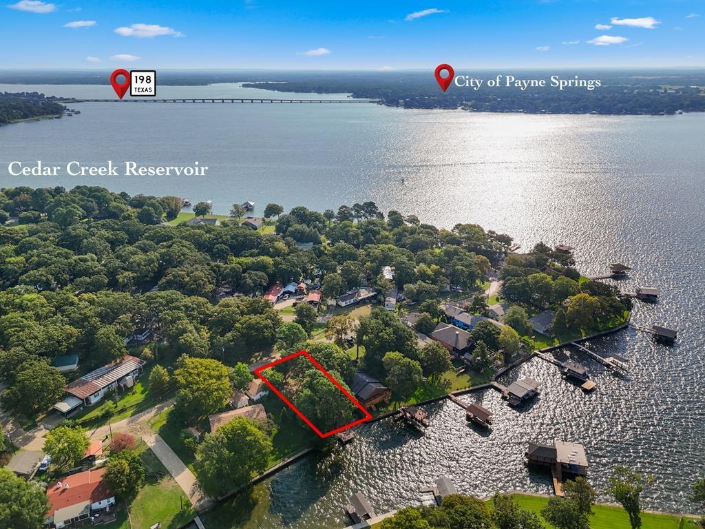 Waterfront lot located in the heart of Gun Barrel City. It's a great opportunity for a tiny house, a new mobile home, or your dream build home on this waterfront lot with great shade trees and even better views. Location is just two lots from POA boat launch in a protected cove, great for swimming and kayaking. This could be a great getaway for a steal of a deal price on good water. There was an old mobile home on the property, so this may have some usable utilities on site.