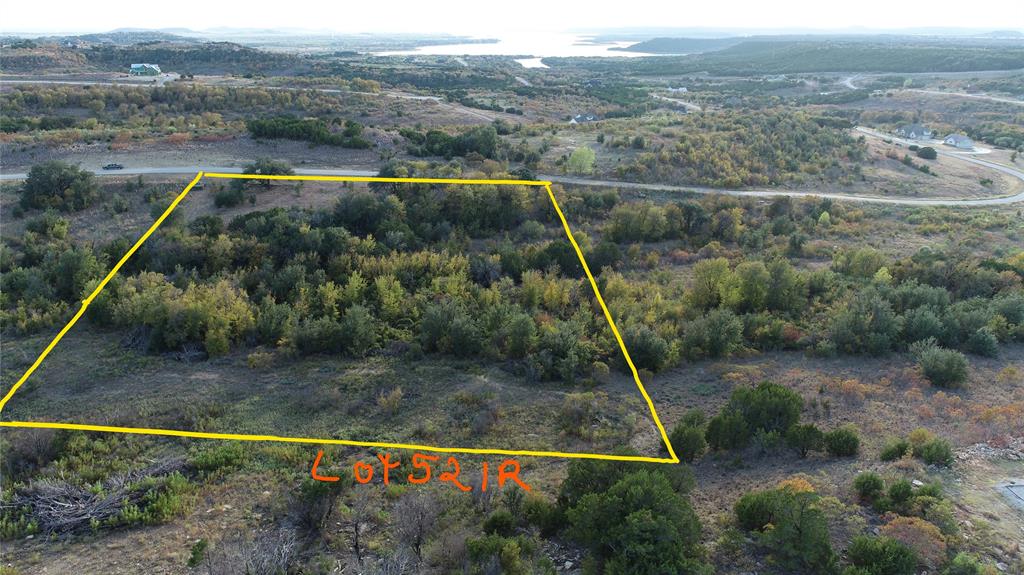 BEST SEEN AND WALKED IN PERSON! This expansive four acre lot is loaded with character and native nuggets! A variety of large mature trees pepper this property giving it shade, trails, privacy, and charm. Several level spots towards the front are ideal for building your dream lake home. This property has plenty of room for many options for creating your perfect space: secondary building, hidden oasis, etc. If you walk through the areas cleared on the property (near the signs) you can cross over the creek area and into the expansive backside that is hidden from sight. The creekbed runs though the property and there is an ideal spot to build a pond. The listing agent can answer more questions about the topography on this gorgeous lot! In the meantime, enjoy the sights and sounds of nature all around including deer, roadrunner, turkeys, owls, and a myriad of other Texas birds. The stars are brighter at night out here in North Texas hill country! You will also enjoy the use of the upscale amenities including the gorgeous community clubhouse infinity swimming pool, community lake cabin, boat dock, boat storage, and watercraft launch area. Spacious fitness center is located inside the community clubhouse with commercial grade equipment, TV, and many large windows to let in the sunshine and beauty all around. The annual 4th of July fireworks show at Hells Gate lands on Saturday July 4th this year if you are out here. Celebrating this bucket list  event for the 250th anniversary of our nation would be a great family memory to start planning now!