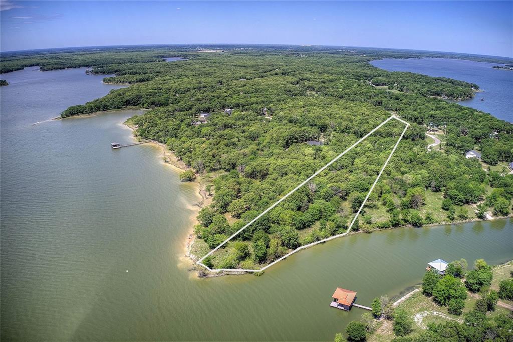 Build Immediately on 1+ Acre Lakefront Lot with 4.5 Acres Usable, Utilities Installed, Largest in Nautical Shores. 

BUILD NOW — no waiting, no guesswork. This rare 1.03-acre lakefront lot in Nautical Shores is fully prepped and ready for construction, saving you months of time and upfront work. With utilities already installed, land cleared, and build requirements completed, you can move straight to building your lake home. What makes this property stand out is not just the size, but the usability. You’ll enjoy over 4.5 acres of total usable space, including an additional 3.48 acres of protected shoreline through the Sabine River Authority, giving you privacy, natural beauty, and direct lake access without neighbors behind you.

The lot is level, cleared, and surrounded by mature hardwoods, including a remarkable centuries-old oak. When water levels recede, a natural sandy shoreline emerges, creating a unique lakefront experience rarely found in this area.

Unlike most lots, everything needed to start building has already been completed. Soil testing, survey, utilities, and site preparation are done. This eliminates months of delays, unexpected costs, and uncertainty, allowing you to focus on designing and building your home immediately.


Skip the time, hassle, and expense — this property is already prepared for construction:

Soil testing completed
Survey completed
Utility meter installed on-site
Site cleared and prepped for building
Approved sewage permitting completed
Architectural plans available 

1.03-acre deeded lot
Approx. 3.48-acre leaseback (SRA)
Total usable space approx. 4.51 acres
HOA: $600-year
Optional boat slip: $500-year
SRA leaseback: approx. $50-year with permit
Dock and pier permitted (up to 150 ft, subject to approval)
Minimum build: 1,400 sq ft (single story), 1,800 sq ft (two story)

Opportunities like this — a build-ready, lakefront lot of this size and usability — are extremely limited in Nautical Shores.