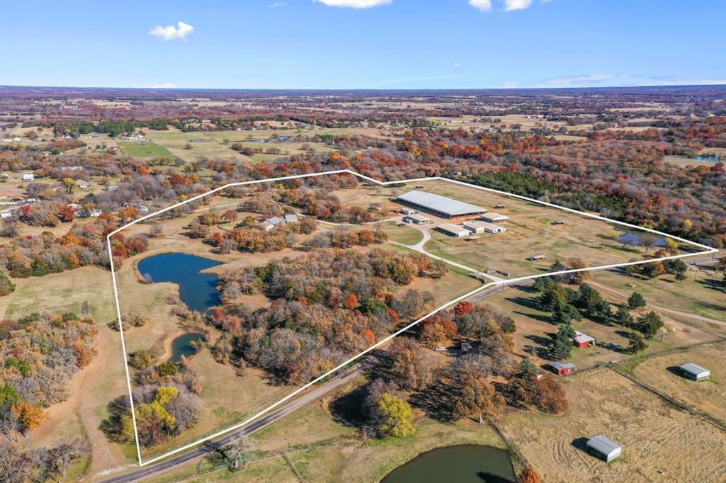This beautiful ranch features 4,557 sq ft of cozy living space with 4 bedroom, 2.5 bathroom, 2 dining areas, office or media room, eat in kitchen and windows throughout to see all around the 42 acres. Above the garage is a 1 bedroom, 1 Bath with living room apartment for a ranch hand or teenager. This magnificent ranch has a newly constructed 140'x330' covered arena with all around footing as well 50' wooden round pen, 3 barns with 35 stalls with a Mare Motel, covered 8 horse walker, paddocks and pastures with run ins, 2 ponds and conveniently located storage for hay and shavings    located right between barns. Schedule your showing today!