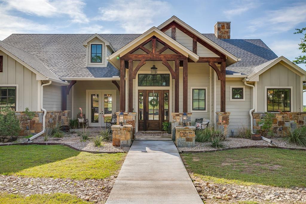 Welcome to an exceptional 25-acre property outside Weatherford, TX where thoughtful design, quality craftsmanship and wide-open space meet in harmony. This custom-built home offers a stunning main residence and a fully functional second living quarters, making it ideal for multi-generational living, guests or income potential. The land is truly something special, with multiple pastures situated on a gentle hilltop offering wide-open views for miles. Whether you’re running livestock, riding or simply soaking in the sunsets, this property embraces the best of country living and benefits from an ag exemption. The main home features 4 spacious bedrooms and 3.5 baths, designed for comfort and functionality. Standout features include solid cedar beams on the front and back porches, a stunning 15-foot kitchen island perfect for gathering and entertaining, additional washer and dryer hookups in the primary closet, and thoughtfully placed hidden electrical outlets in all bathroom cabinets and pantry for a clean, streamlined look. For the chef in the family you will love the thought put into the design and flow of the kitchen. Complete with all Thermador appliances including a built-in refrigerator and freezer tower with matching cabinet panels, 48” gas range, built-in drawer microwave, professional hood and dishwasher. In addition there are 2 sinks with garbage disposals and a pot filler over the range. All of this centered around the oversized 5’ X 15’ island that has additional storage on the back-side. In addition to the primary residence, the property includes a separate approximately 1,400-square-foot guest home complete with two bedrooms and two bathrooms, offering privacy and flexibility for extended family or visitors. For those who need space to work, store, or create, the impressive 60x40 workshop is a standout feature, complete with drive-through doors. An attached carport provides ample room for RV parking, making this property as practical as it is beautiful.